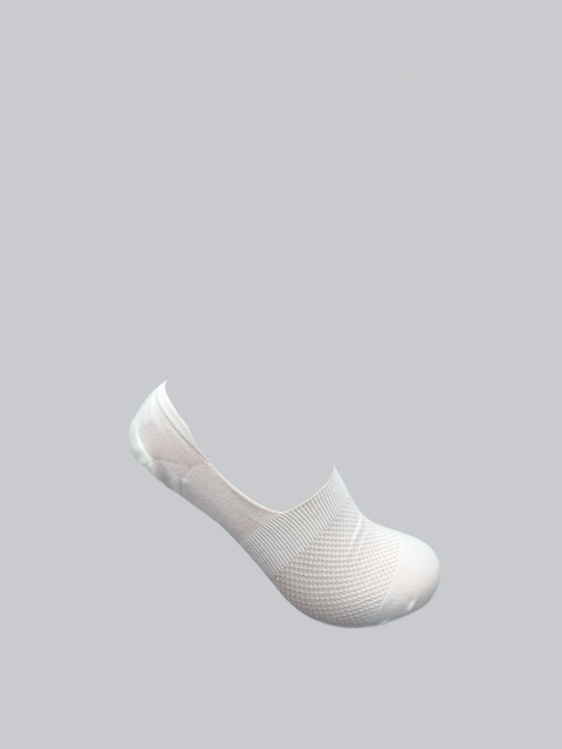 A single M1 No Show Sock by ID Menswear is set diagonally on a gray background. Made from soft, combed cotton, it has a textured pattern and low-cut design, ideal for discreet wear with low-cut shoes.