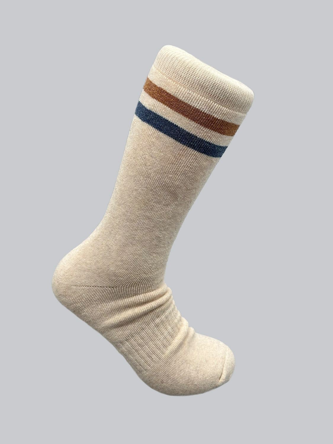 The Rutland Cotton Melange Sock by ID Menswear is a premium cotton winter essential in beige, featuring brown, white, and blue stripes near the top. Posed as if worn, it stands out against a plain gray background.