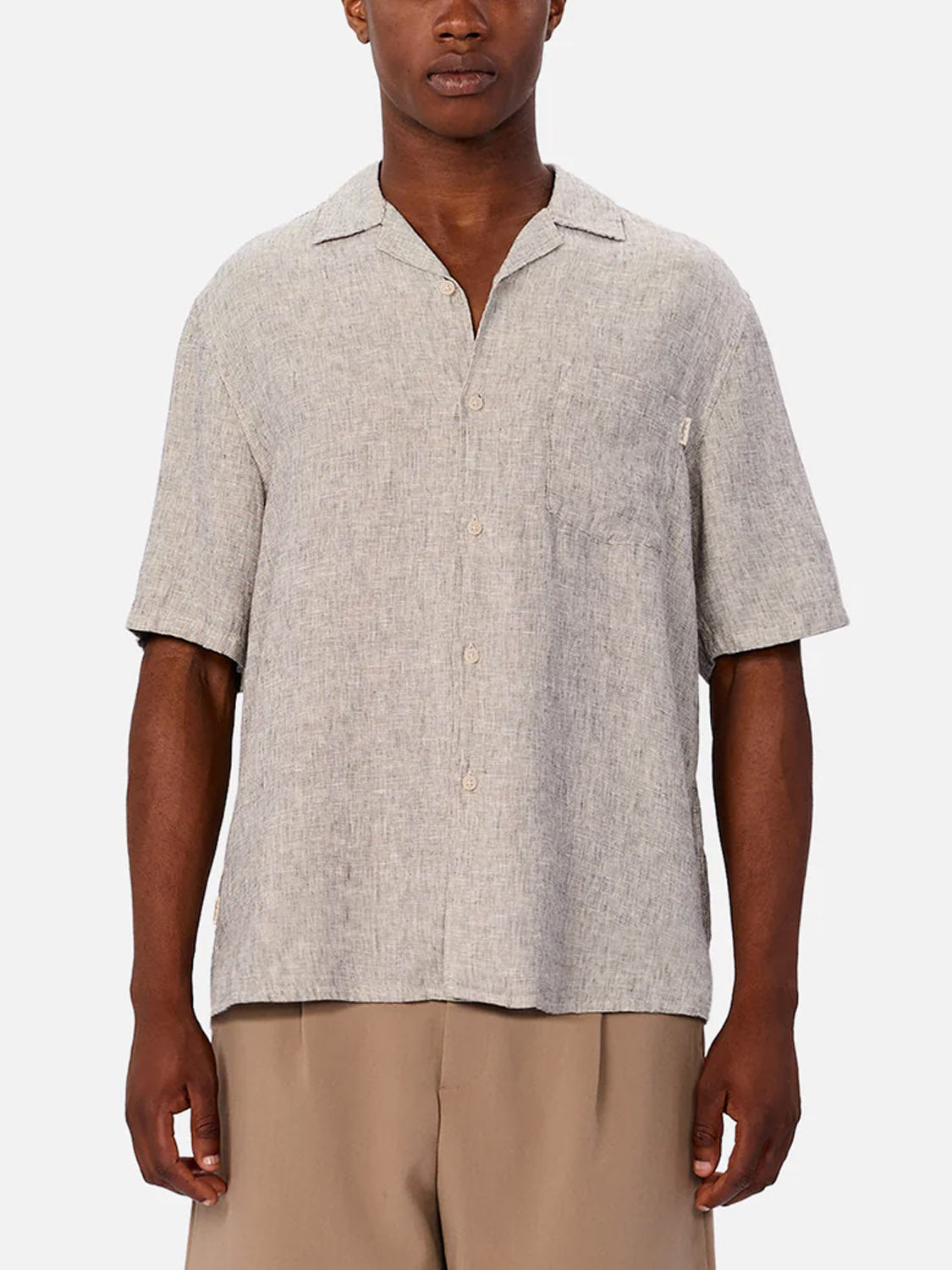 A person wears the Industrie Melrose Short Sleeve Shirt in light grey with a relaxed fit and beige pants, standing against a plain white background.