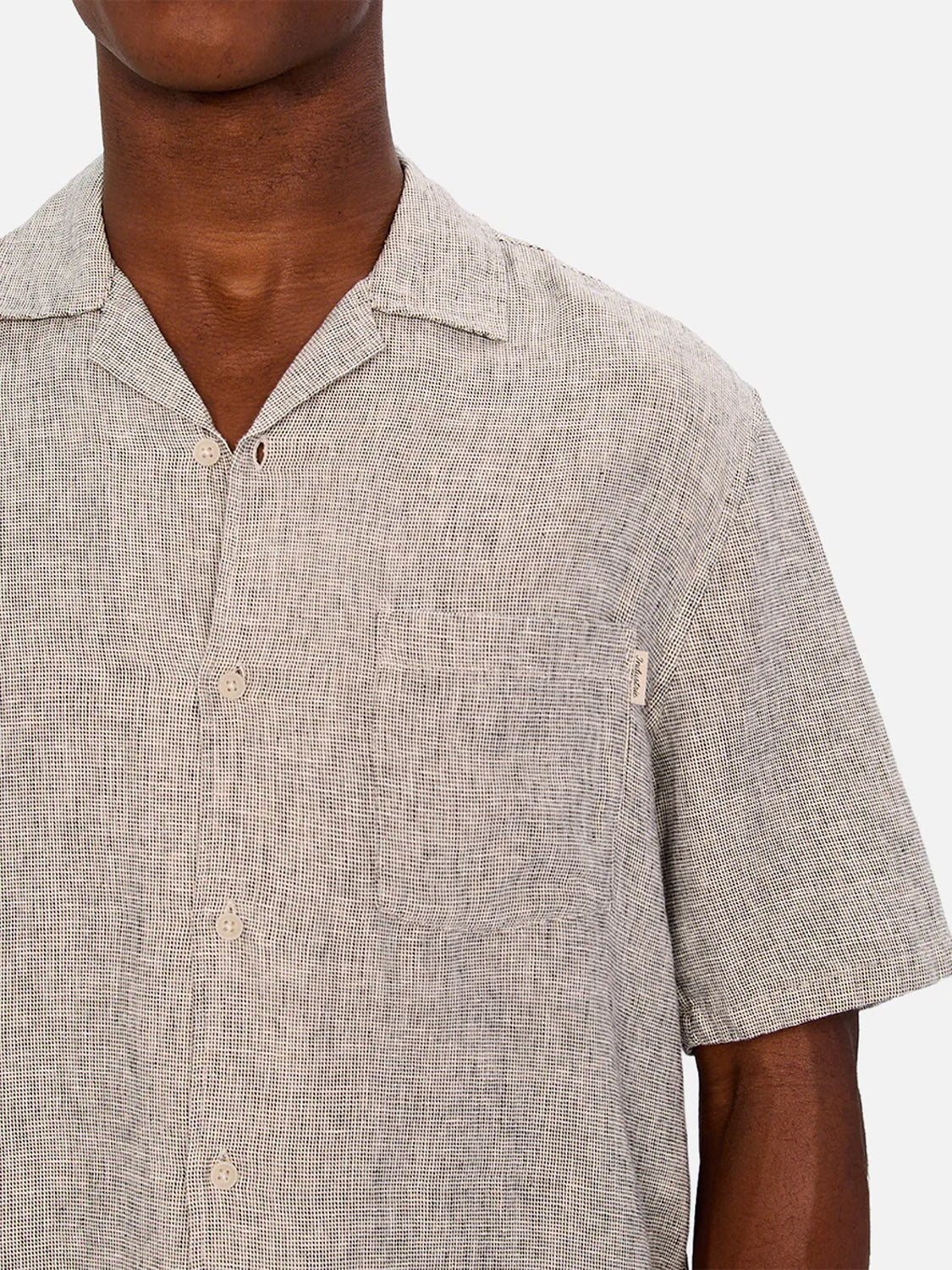 A person wearing the Industrie Melrose Short Sleeve Shirt in light grey with a subtle grid pattern, shown from shoulders to mid-torso against a plain background.