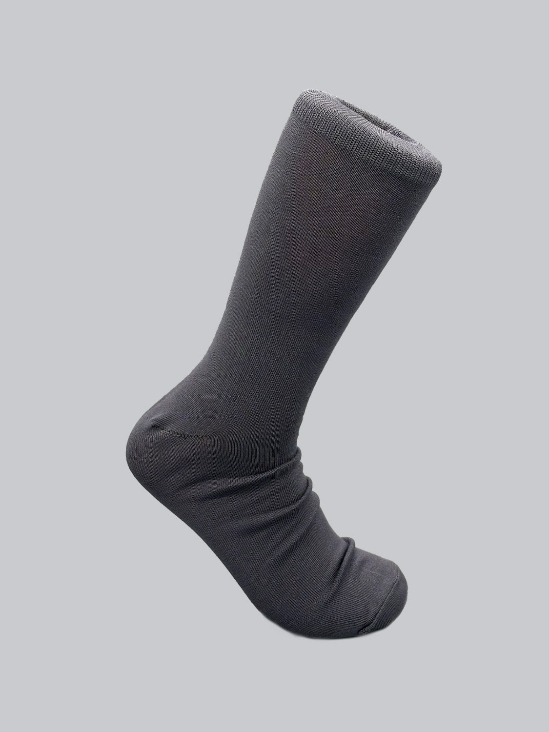 A single dark grey luxury sock by ID Menswear, part of their Mercerized Cotton Socks collection, features a ribbed cuff and is partially rolled, standing vertically on a light grey background.