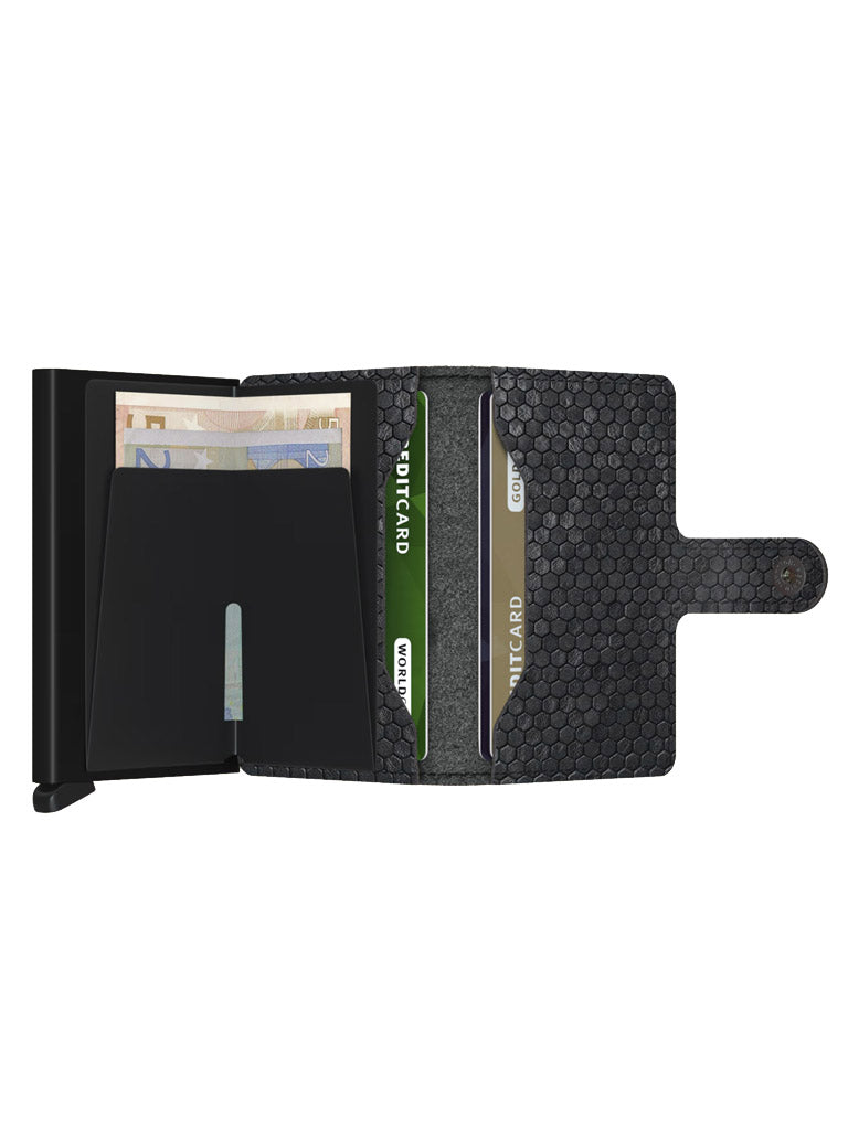 The Secrid Miniwallet Hexagon is a compact black leather wallet with a textured pattern, featuring compartments for cash and three cards, including an ID card, plus a right-side snap closure tab for security.