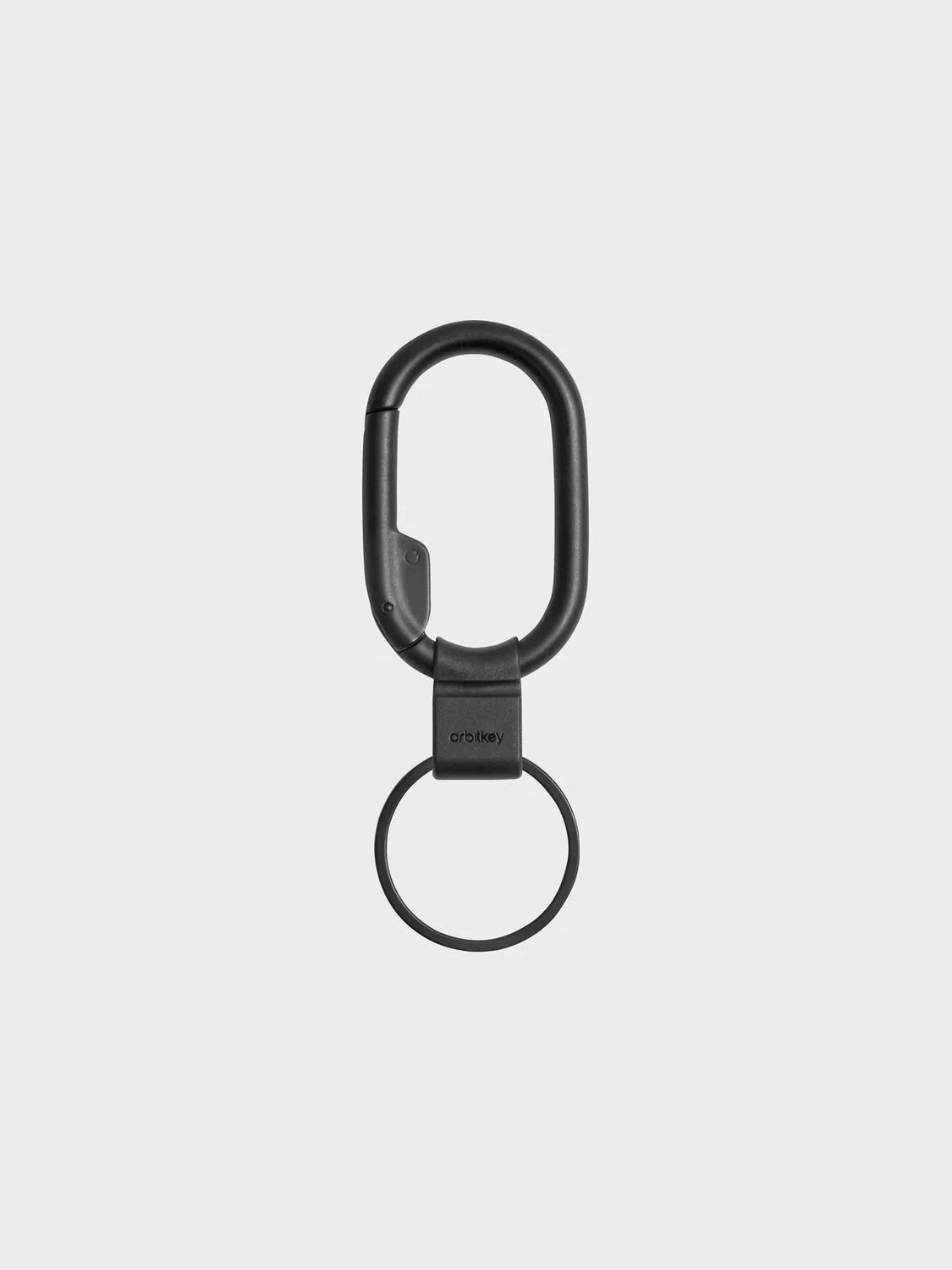 The Orbitkeys Clip Mini Keyring, a black minimalist carabiner keychain with a circular ring, is shown vertically against a plain light gray background.