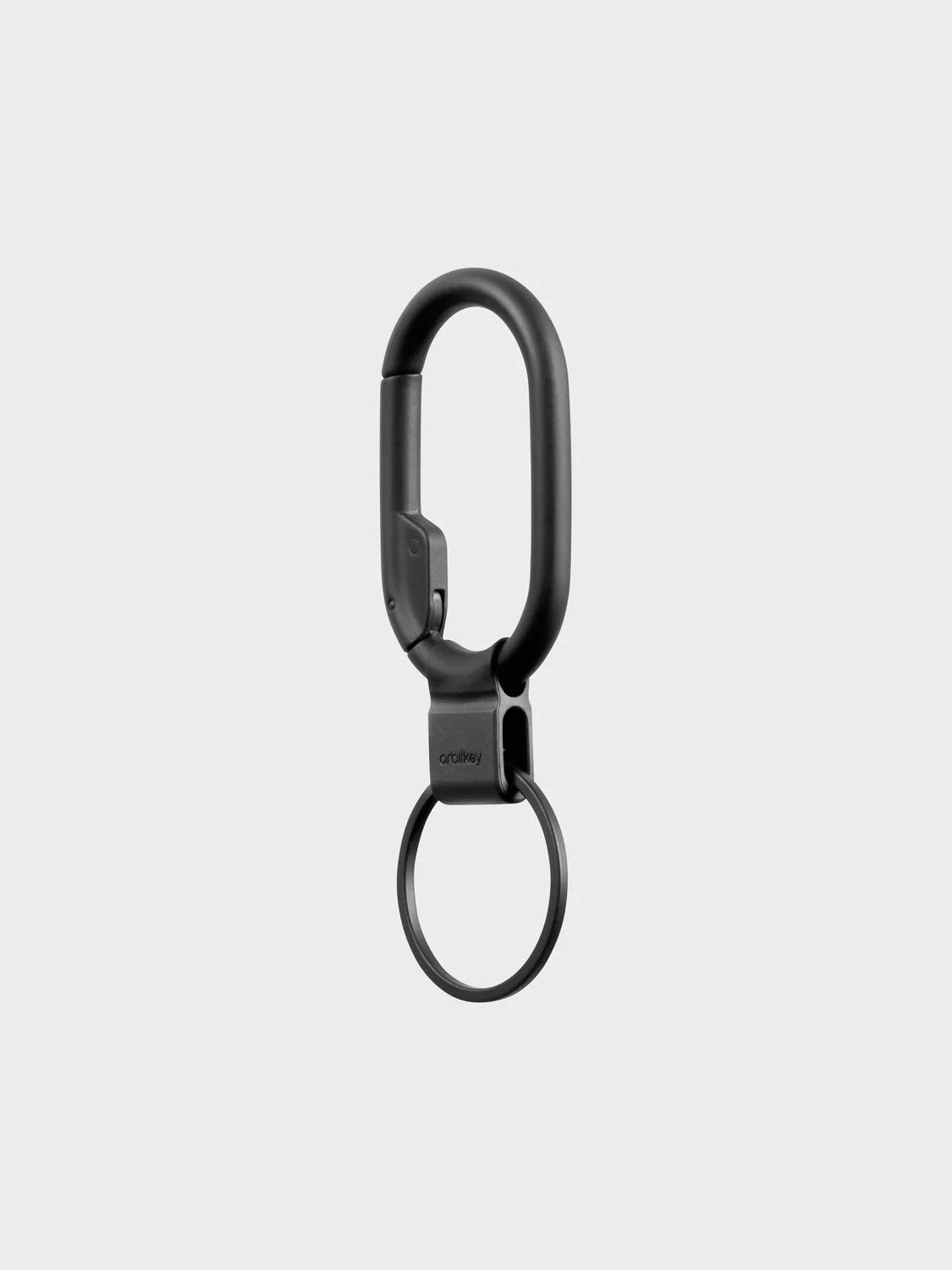 The Orbitkeys Clip Mini Keyring, featuring a black metal minimalist carabiner and oval clip on a round ring, is displayed against a plain light gray background.