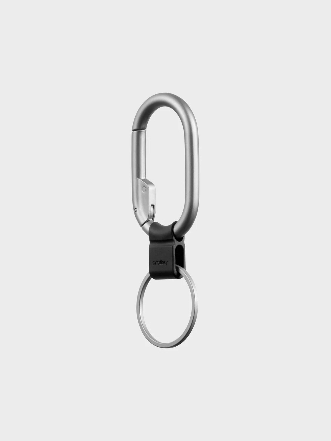 The Orbitkeys Clip Mini Keyring features a silver minimalist carabiner with a black hinge, attached to a round quick-release keyring, shown on a plain light gray background.