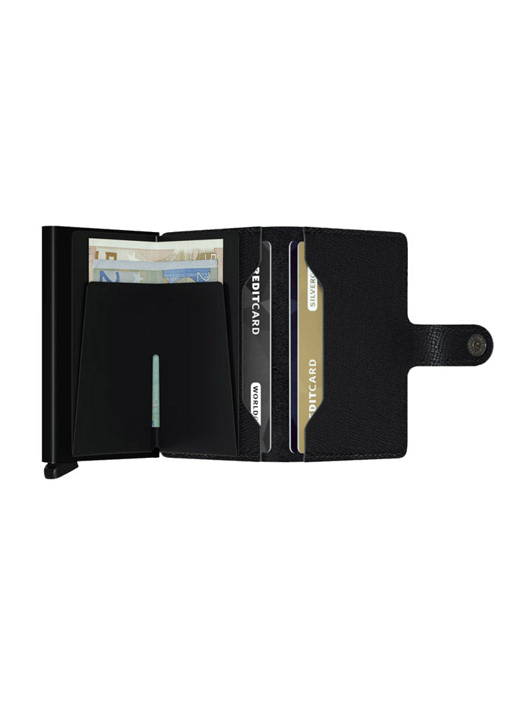 The Secrid Miniwallet Crisple in black leather opens to reveal compartments for euro banknotes and three cards, featuring RFID protection and a right-side snap-button closure.