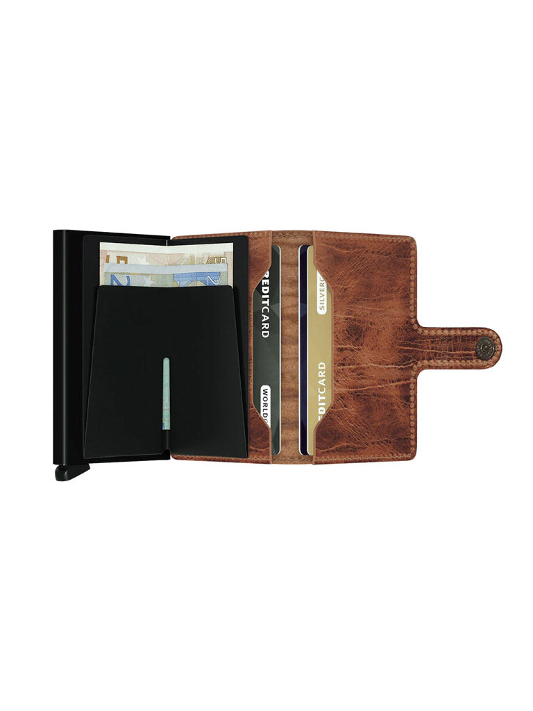 A Secrid Miniwallet Dutch Martin, an open brown leather RFID wallet with multiple card slots holding credit cards and a compartment for paper currency, is displayed on a white background.
