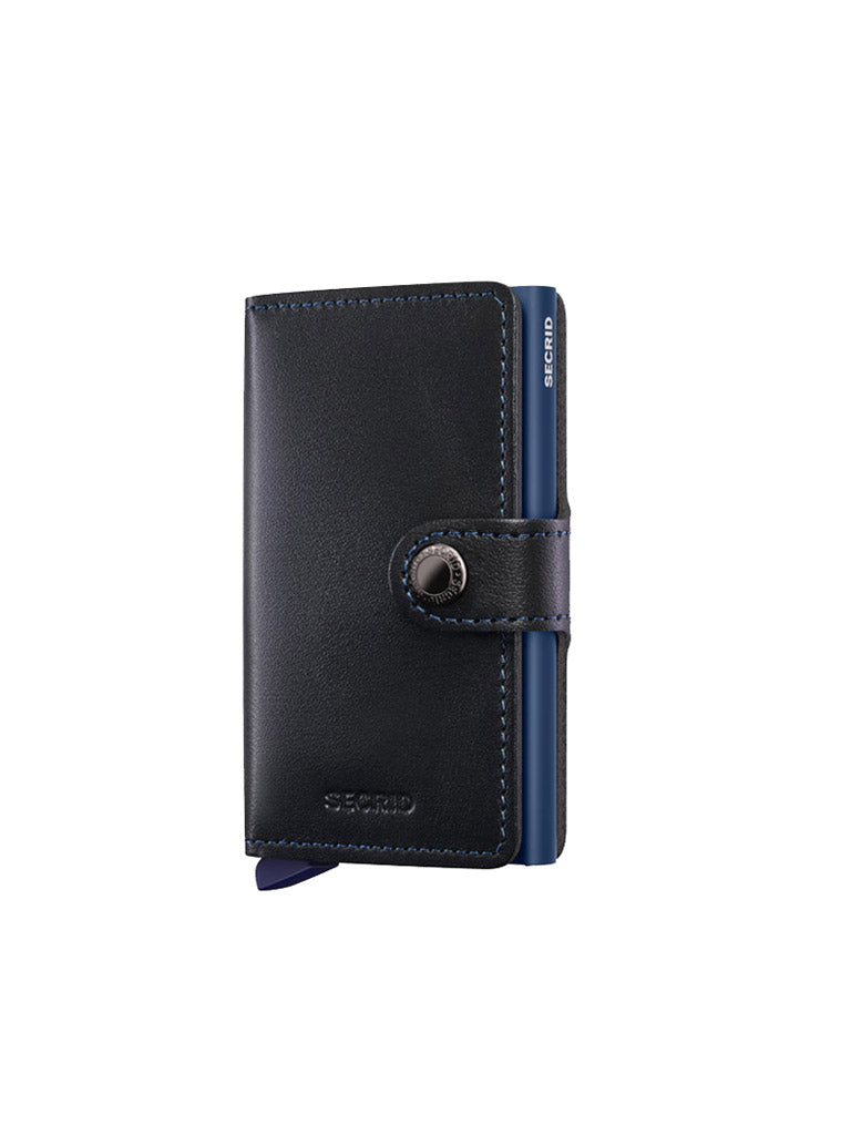 The Secrid Miniwallet Original by Secrid is crafted from black European leather, features blue accents, a button snap closure, RFID protection, and a blue cardholder section on the side.