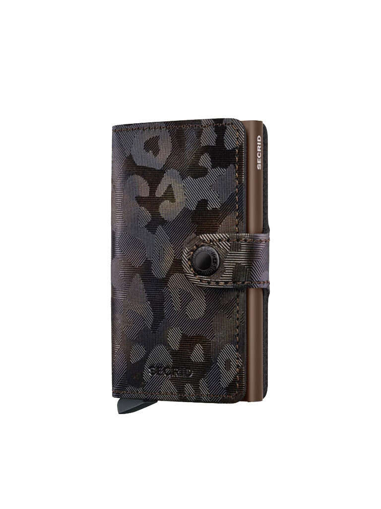The Secrid Miniwallet Jungle by Secrid is a compact wallet made from premium European leather, featuring a dark abstract textured pattern and snap-button closure—an RFID-secure accessory shown standing upright against a white background.