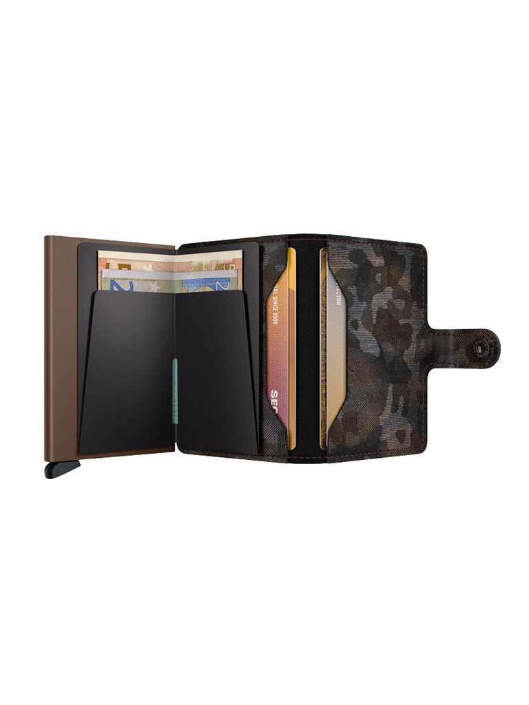 The Secrid Miniwallet Jungle by Secrid is a European leather wallet with a camouflage pattern, black card slots, snap closure, pull-tab section on the left, and added RFID protection to keep your essentials secure.