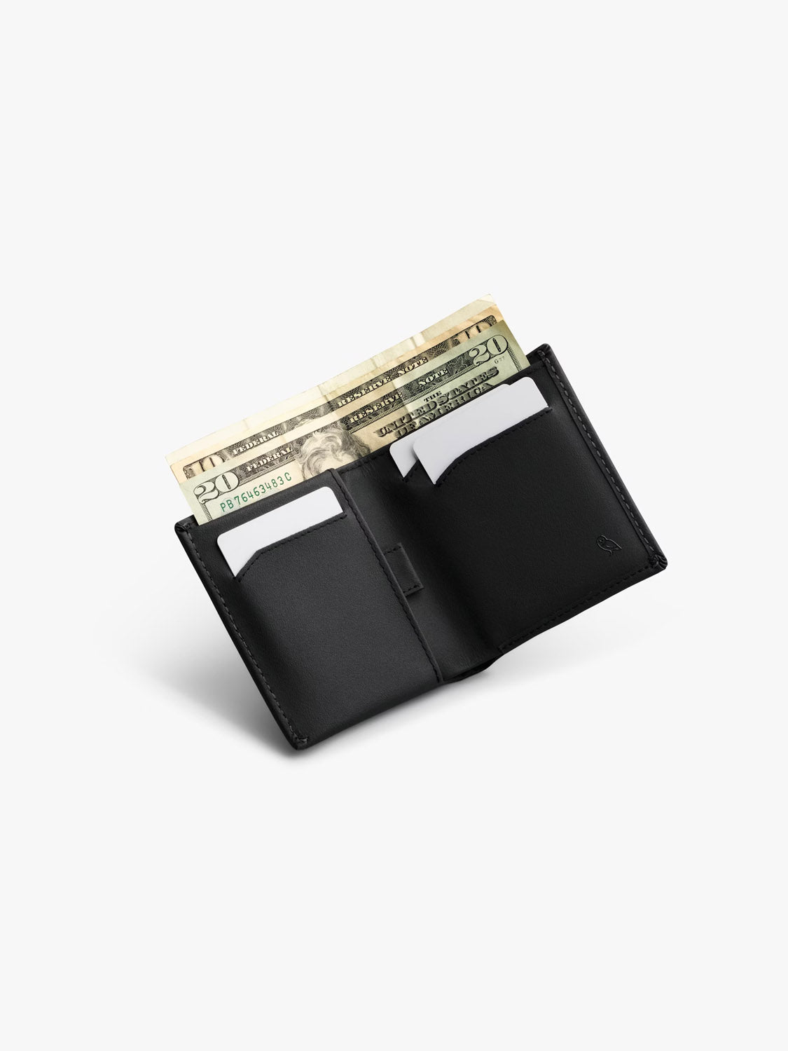 A Bellroy Note Sleeve Innovera™ Edition wallet with RFID protection is open to show two folded $20 bills and several white cards in its compartments, set against a plain white background.