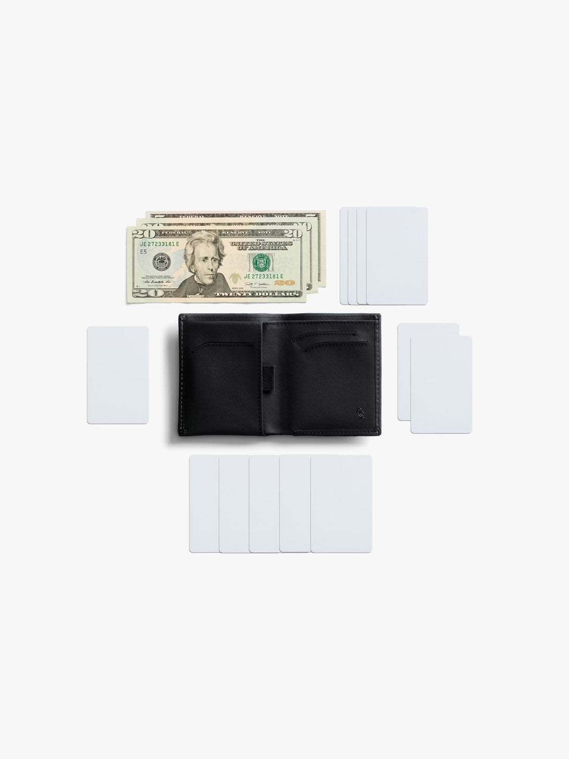 A Bellroy Note Sleeve Innovera™ Edition wallet in black leather is open on a white background, surrounded by blank white cards, with U.S. dollar bills arranged above its RFID-protected billfold.