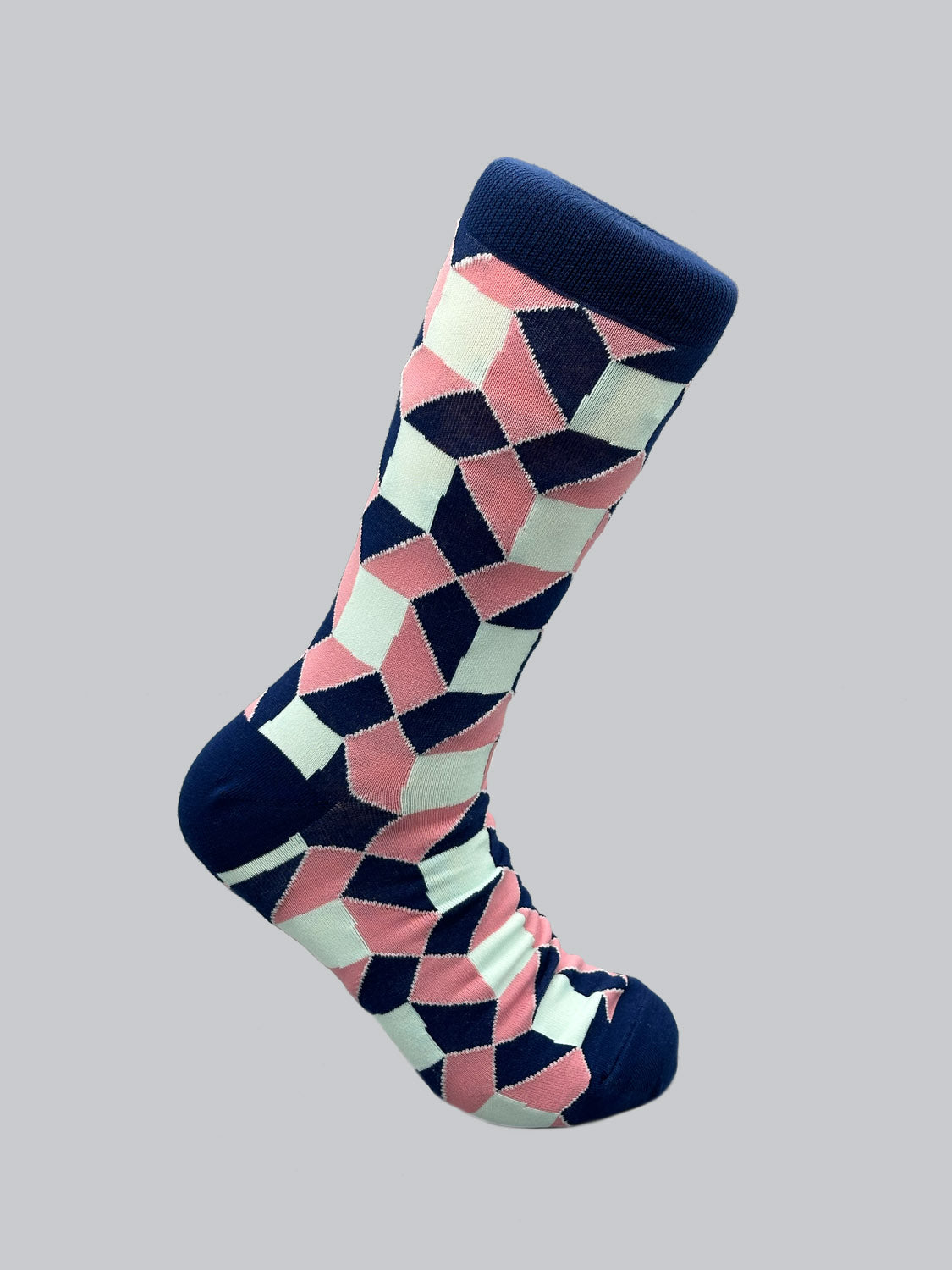 The Octto Graphic Socks by ID Menswear feature a geometric pattern with navy blue, light blue, and pink shapes on a gray background. Made from combed cotton for mens shoe sizes 8-12, they have contrasting navy toe, heel, and cuff.