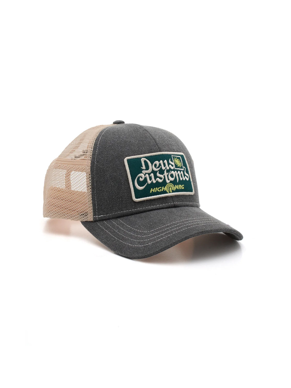 The Deus Open Head Trucker is a two-tone classic fit hat with a dark gray cotton twill front, beige mesh back, and a green and white rectangular patch reading "Deus Customs" and "High Wings" on the front.
