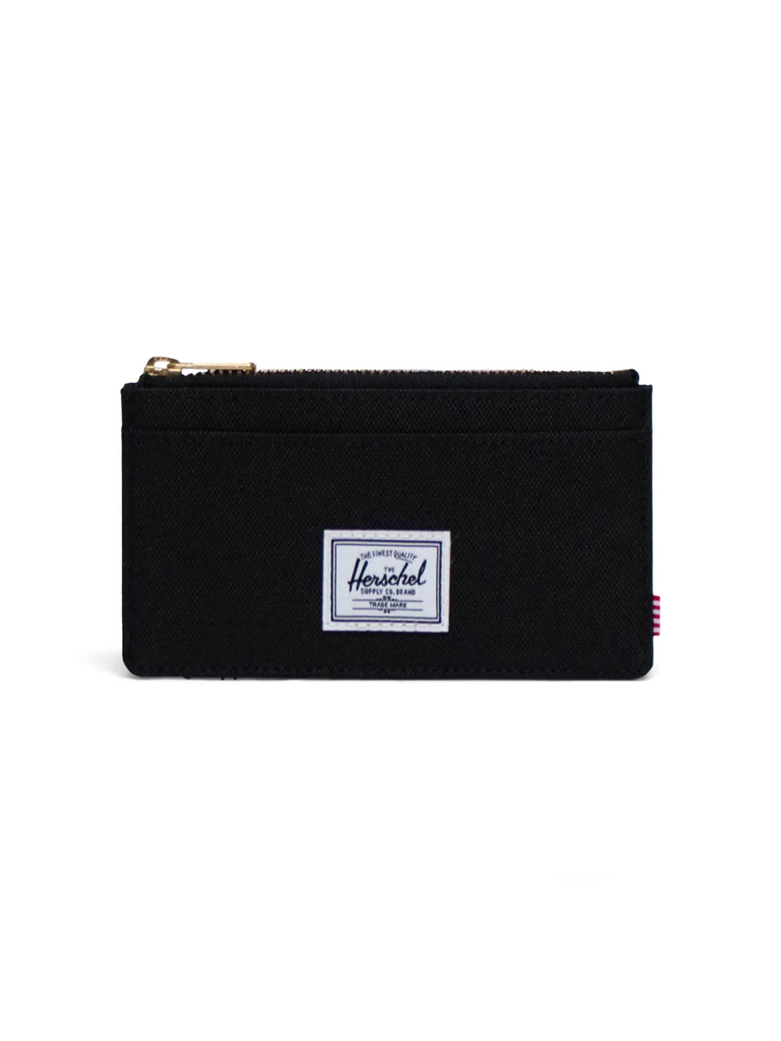 The Oscar Large Cardholder Wallet by Herschel is a black zippered wallet made from recycled polyester, featuring RFID blocking, a gold zipper, rectangular white brand label on the front, and a small red-and-white striped side tag.