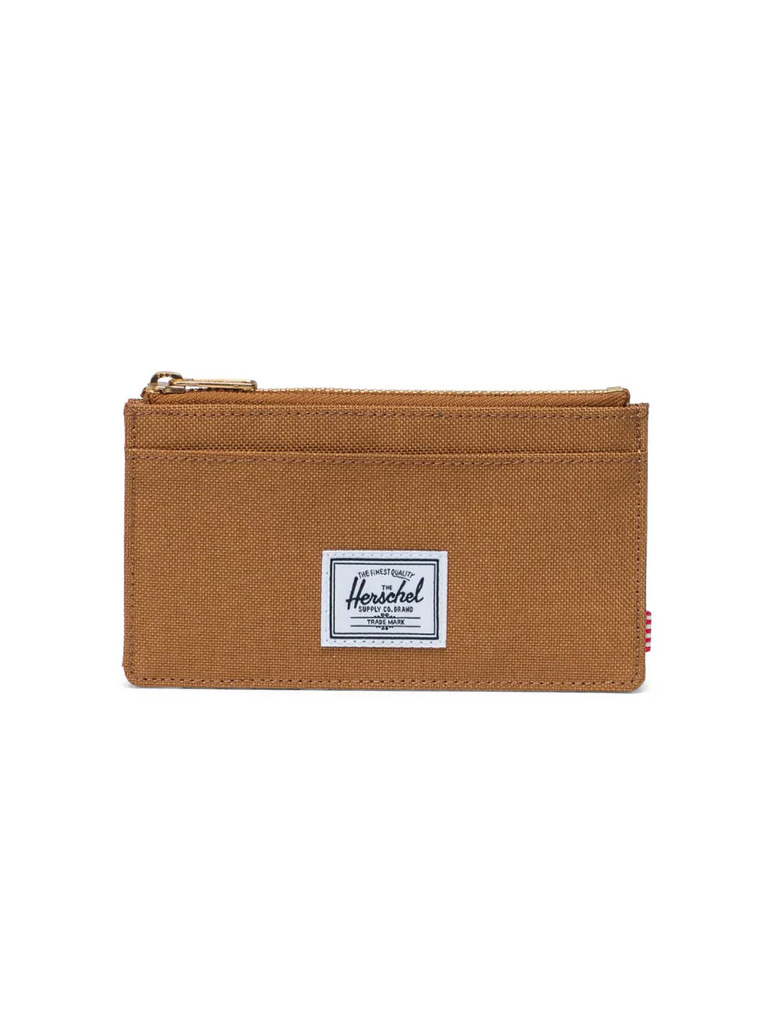 The Herschel Oscar Large Cardholder Wallet is a brown canvas wallet made from recycled polyester, featuring a top zipper, visible stitching, RFID blocking, a white Herschel label on the front, and a small red side tag.