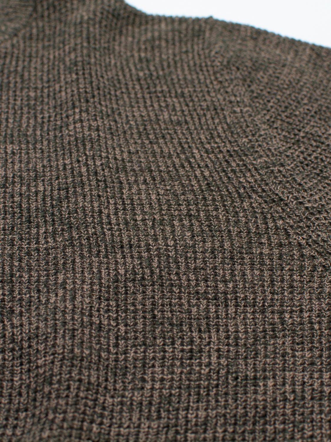 Close-up of the Oslo Waffle Knit Sweater by ID Menswear in textured dark brown, featuring small, tightly woven stitches for a warm and cozy look. Lighting highlights its detailed texture and rich color, making it perfect for casual wear.