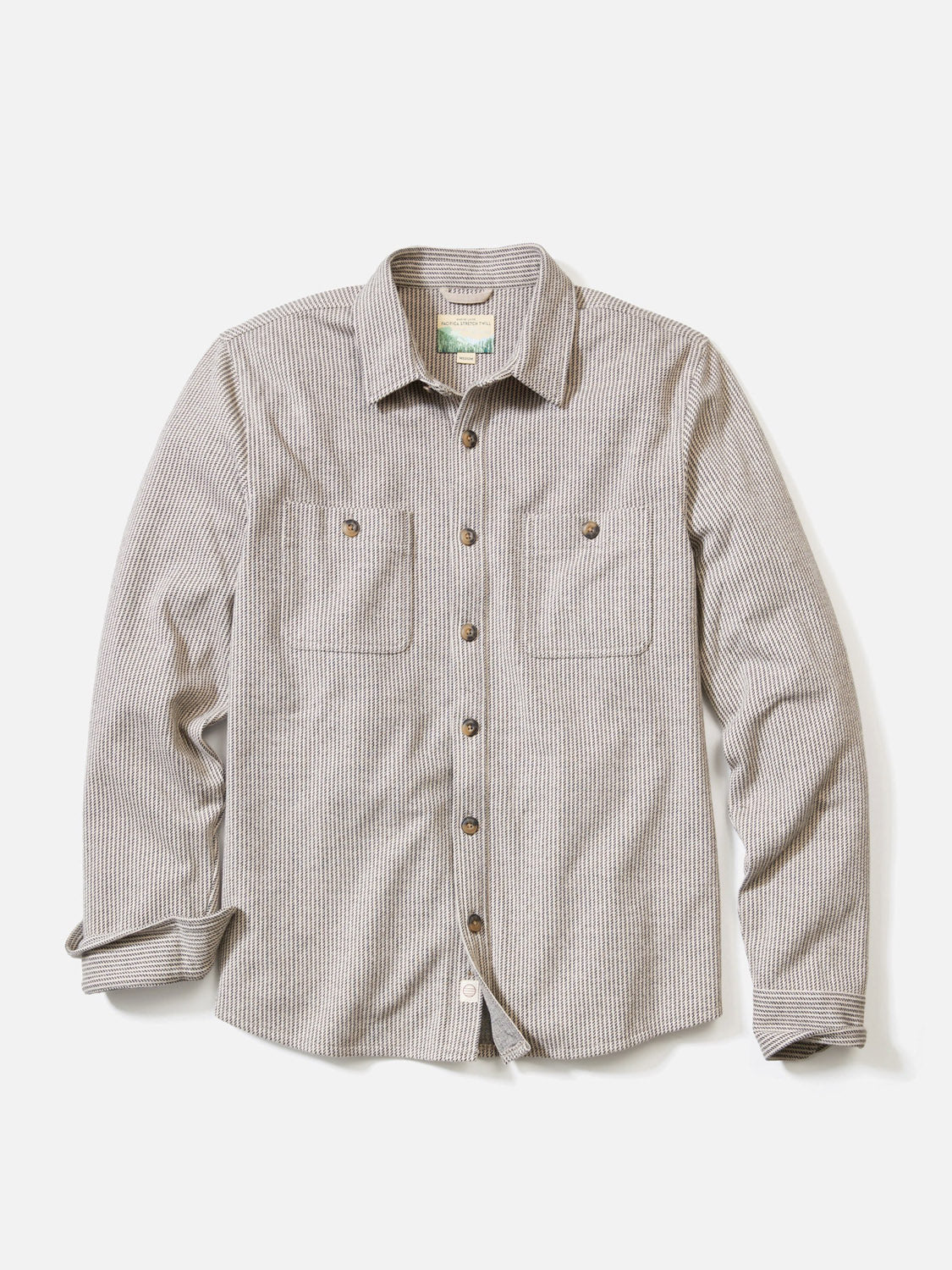 The Marine Layer Pacific Stretch Grey Twill Overshirt is a long-sleeve, classic fit shirt with two button-flap chest pockets, made from medium-weight fabric and shown laid flat on a white background.