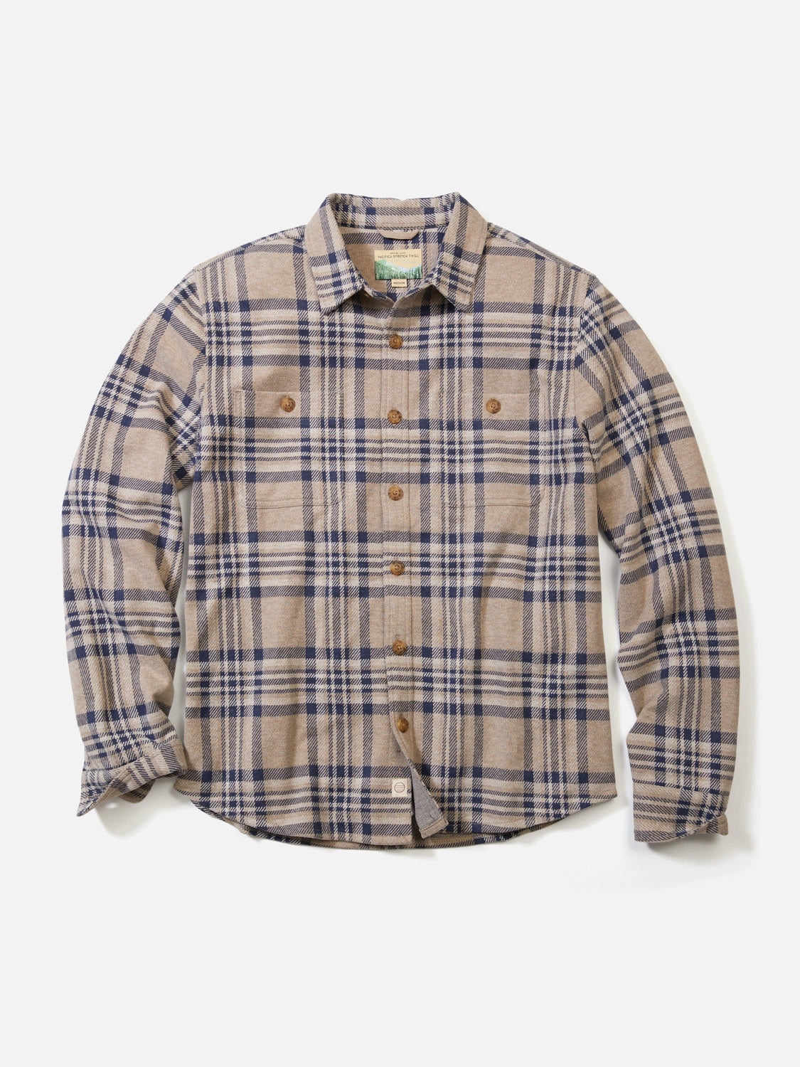 The Marine Layer Pacific Stretch Plaid Twill Overshirt is a lightweight, long-sleeve button-up with a beige and navy plaid pattern, two chest pockets, and brown buttons, shown laid flat on a white background.