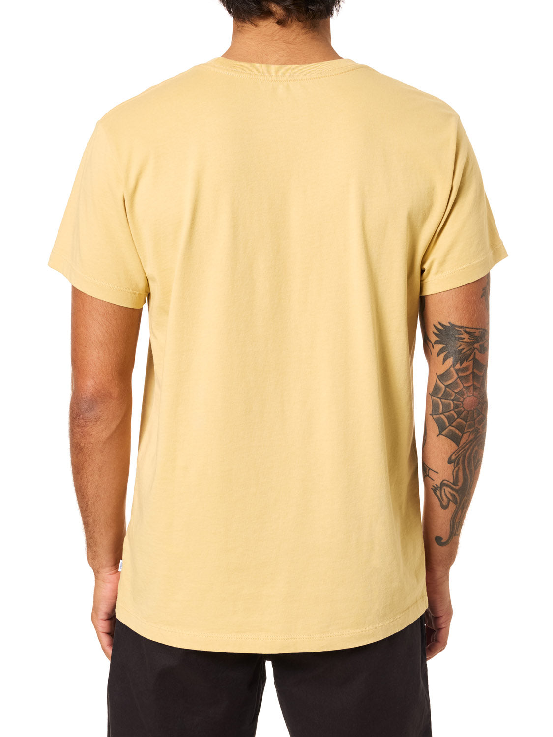 A person with a tattooed right arm is seen from behind, wearing the Katin K-Palm Embroidered Tee by Katin and black pants.