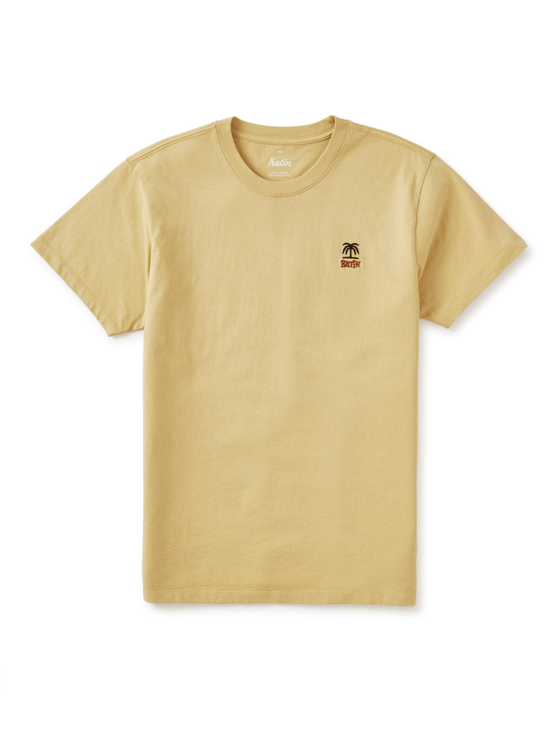 The Katin K-Palm Embroidered Tee by Katin is a plain beige organic cotton short-sleeve t-shirt with a small black palm tree and SURF graphic on the left chest, shown laid flat on a white background.
