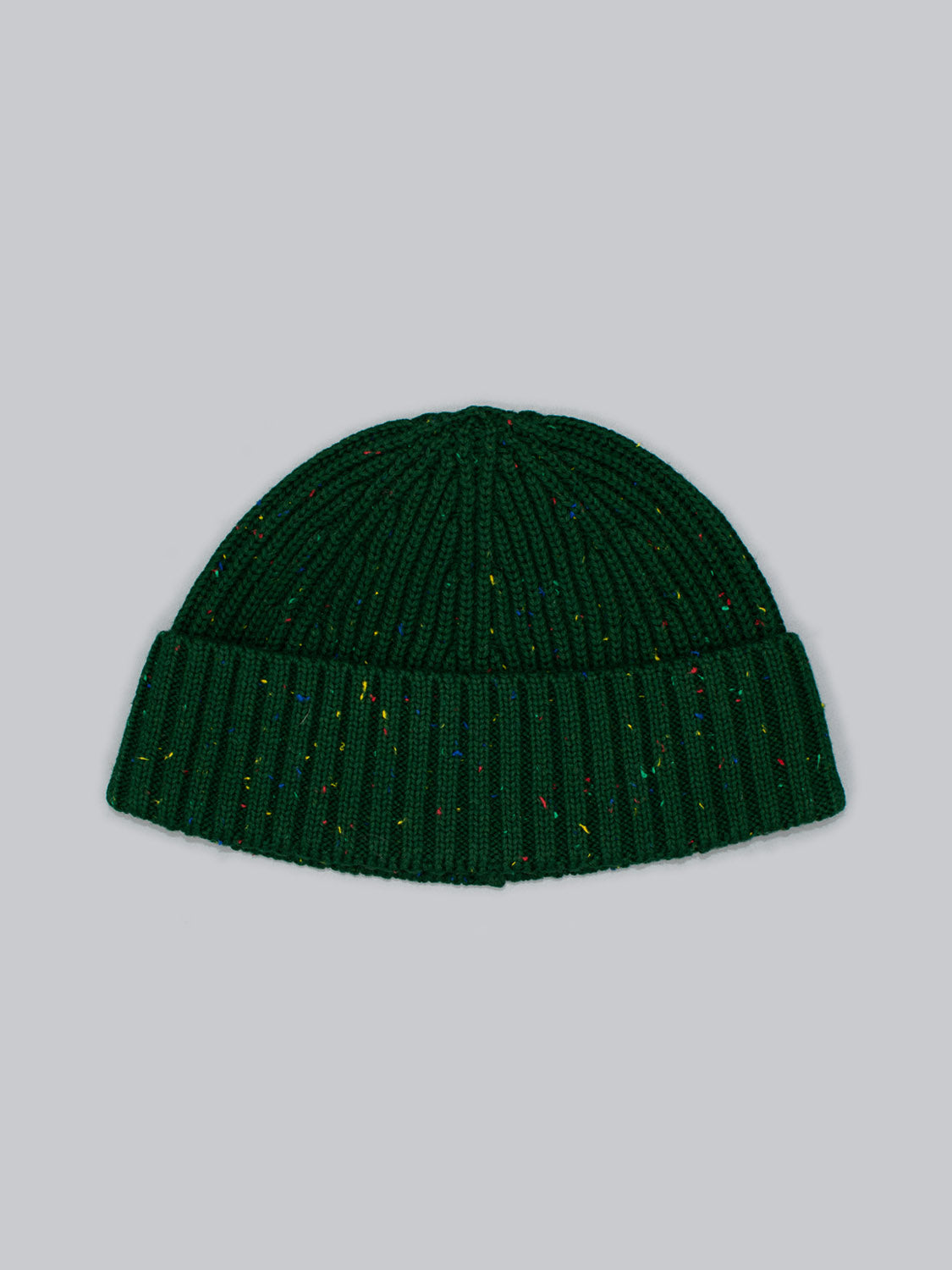 The Paro Speckled Cotton Fishermans Beanie by ID Menswear features a classic design with a folded brim and vibrant speckled yarn on a light gray background.