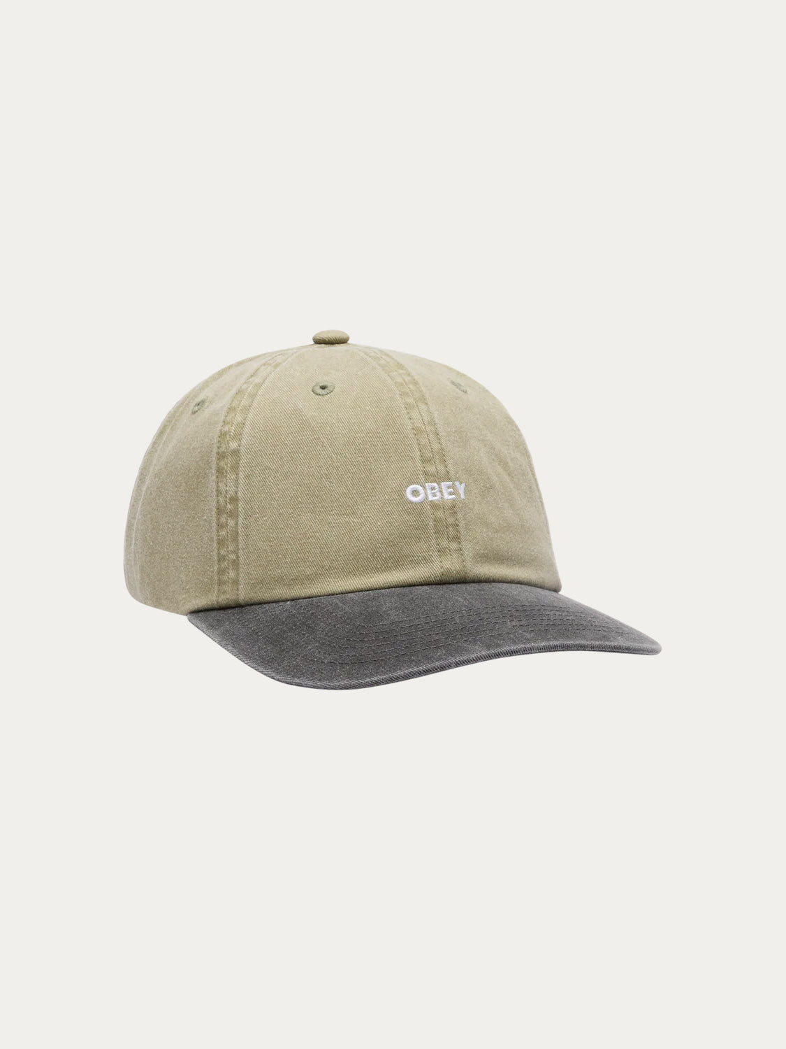 The Obey Pigment Bold 6 Panel Strapback features a two-tone design with an olive green crown, dark gray brim, 100% cotton fabric, and a white embroidered OBEY logo on the front.