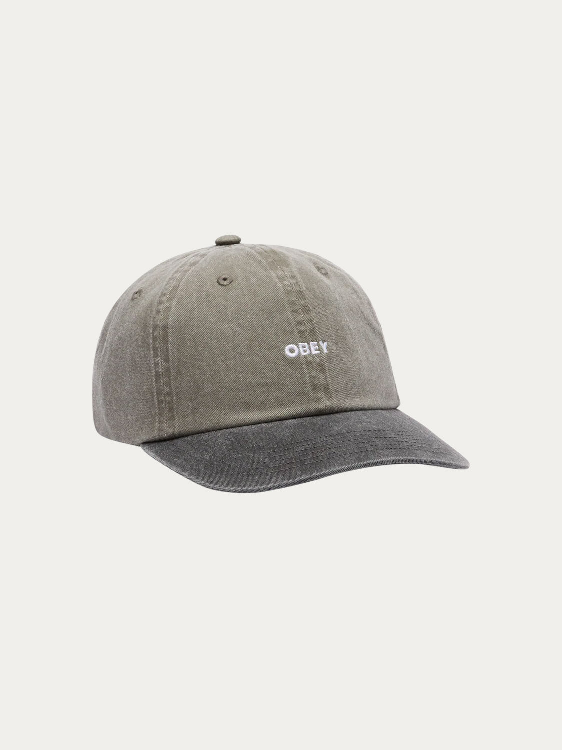 The Obey Pigment Bold 6 Panel Strapback is a gray 100% cotton baseball cap with a slightly curved brim, white embroidered Obey logo, visible stitching, and an adjustable strapback for a classic vintage look.