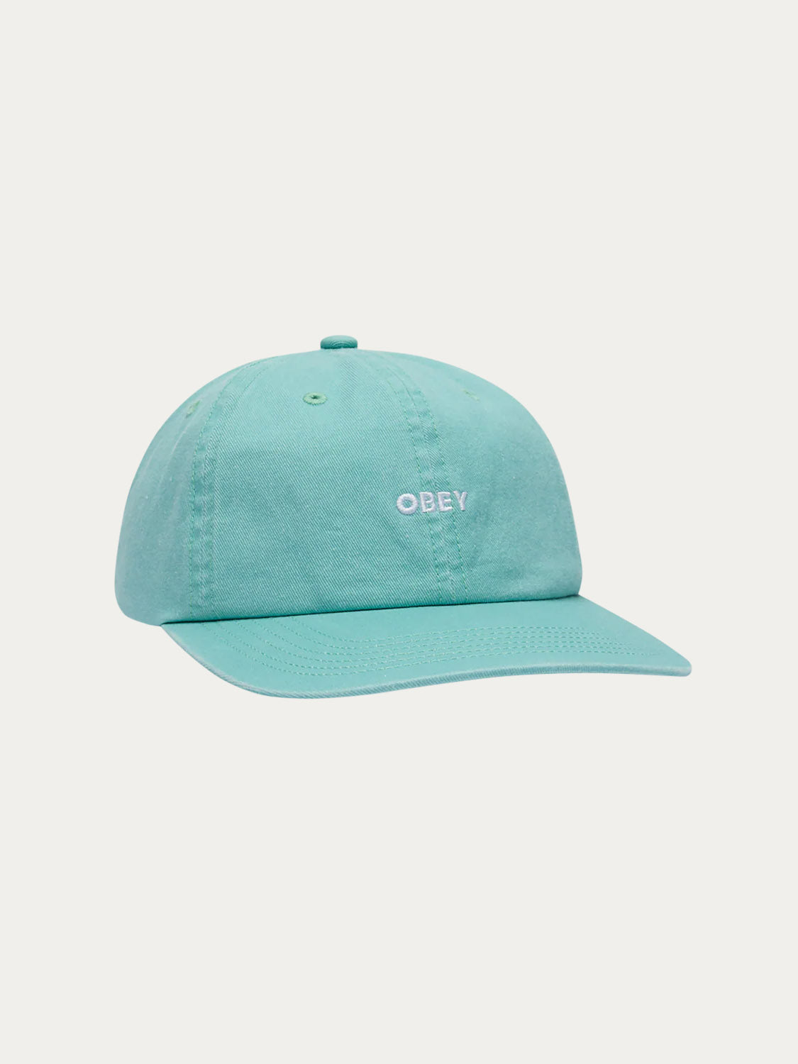 The Obey Pigment Bold 6 Panel Strapback is a turquoise 100% cotton hat with the OBEY logo embroidered in white on the front, displayed against a plain white background.
