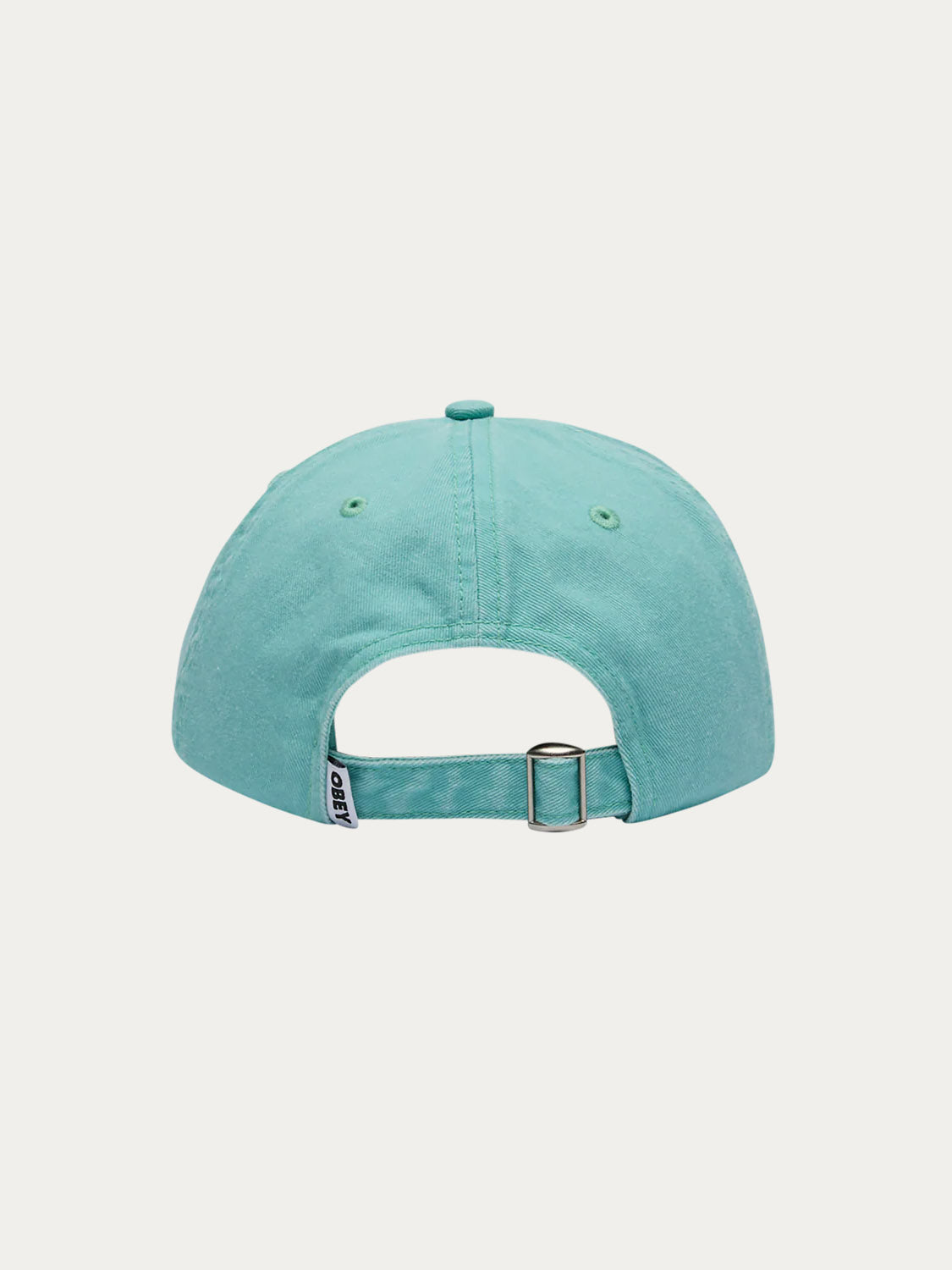 The Obey Pigment Bold 6 Panel Strapback is shown from the back in teal, featuring an adjustable metal clasp strap, a small fabric tag, and 100% cotton construction against a plain white background.