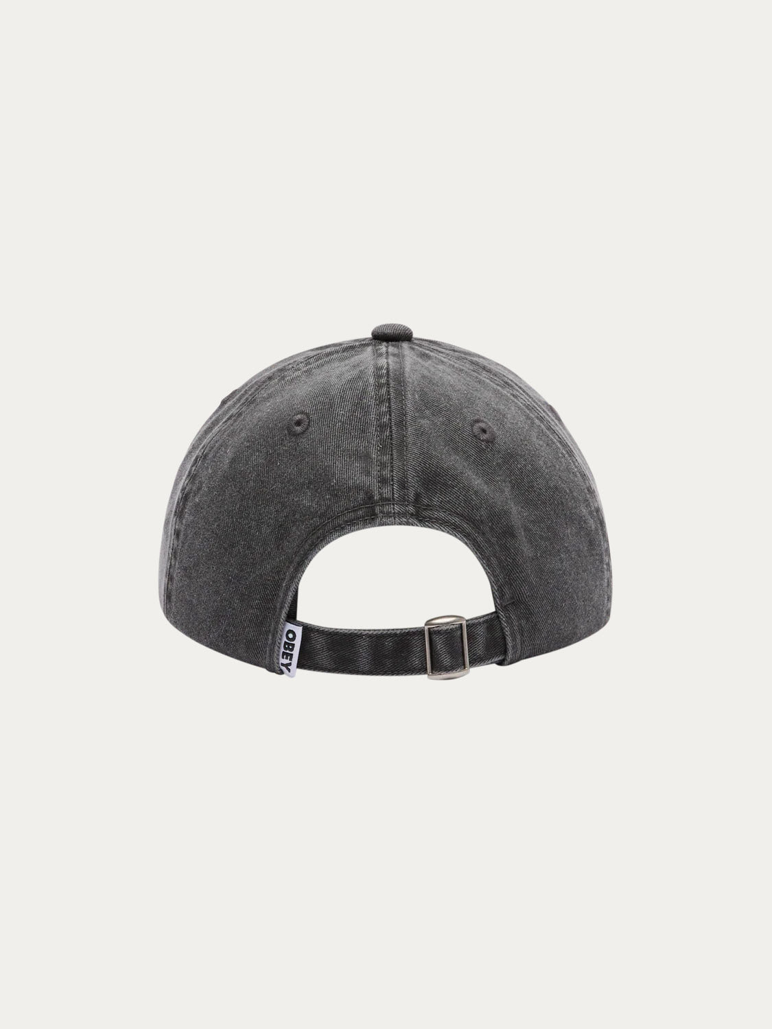 Back view of the Obey Pigment Productions SNPB cap in washed black 100% cotton, featuring a strap back closure with metal buckle and a small black and white tag near the rear opening. Shown against a plain white background.