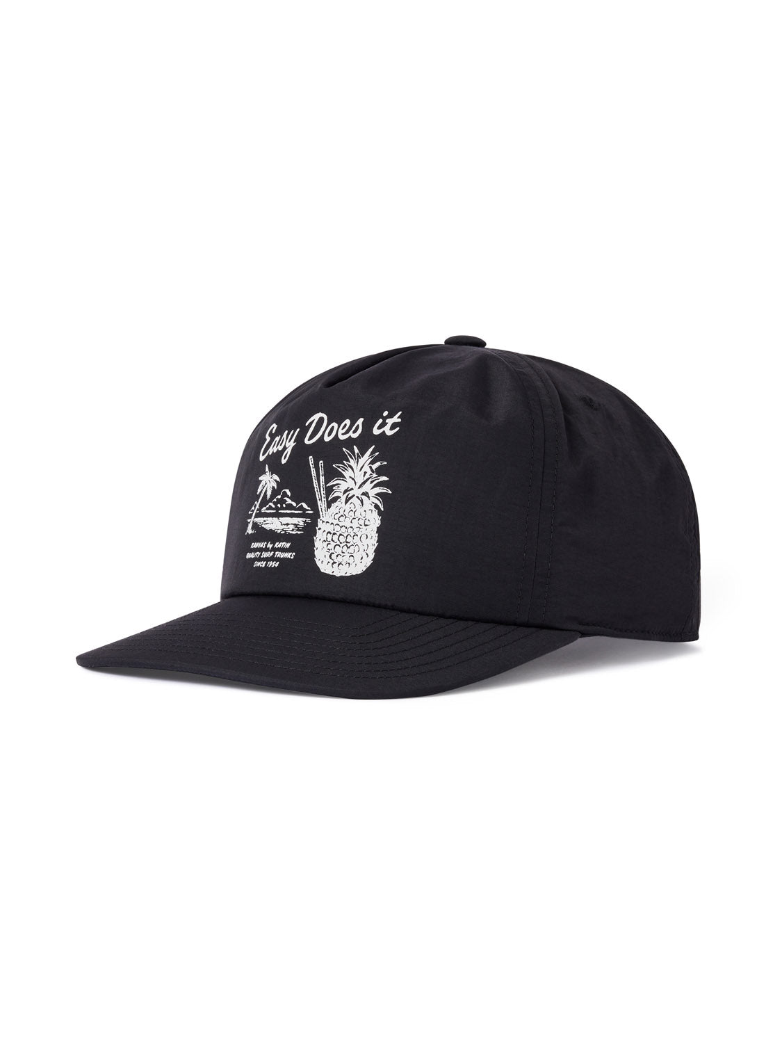 Explore the Katin Pina Nylon Hat, a chic black cap with white embroidery of a pineapple sipping through straws, the text Easy Does It, and palm trees and waves in the background. It offers a comfortable fit with its snapback closure.