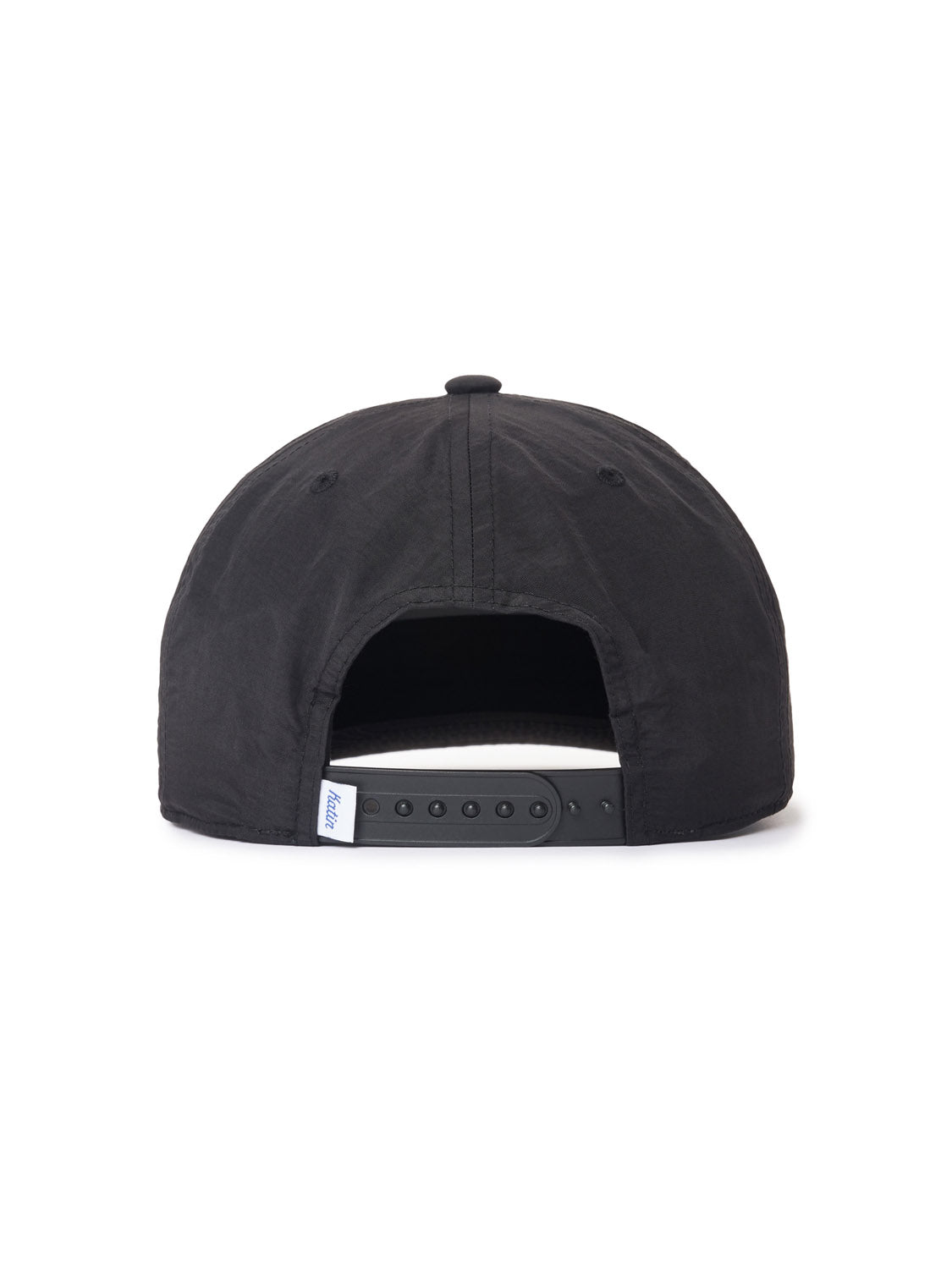 The Katin Pina Nylon Hat is a black baseball cap seen from the back, featuring a Snapback closure with an adjustable strap and a small white label on the left side. It embodies Katins classic design and premium craftsmanship.