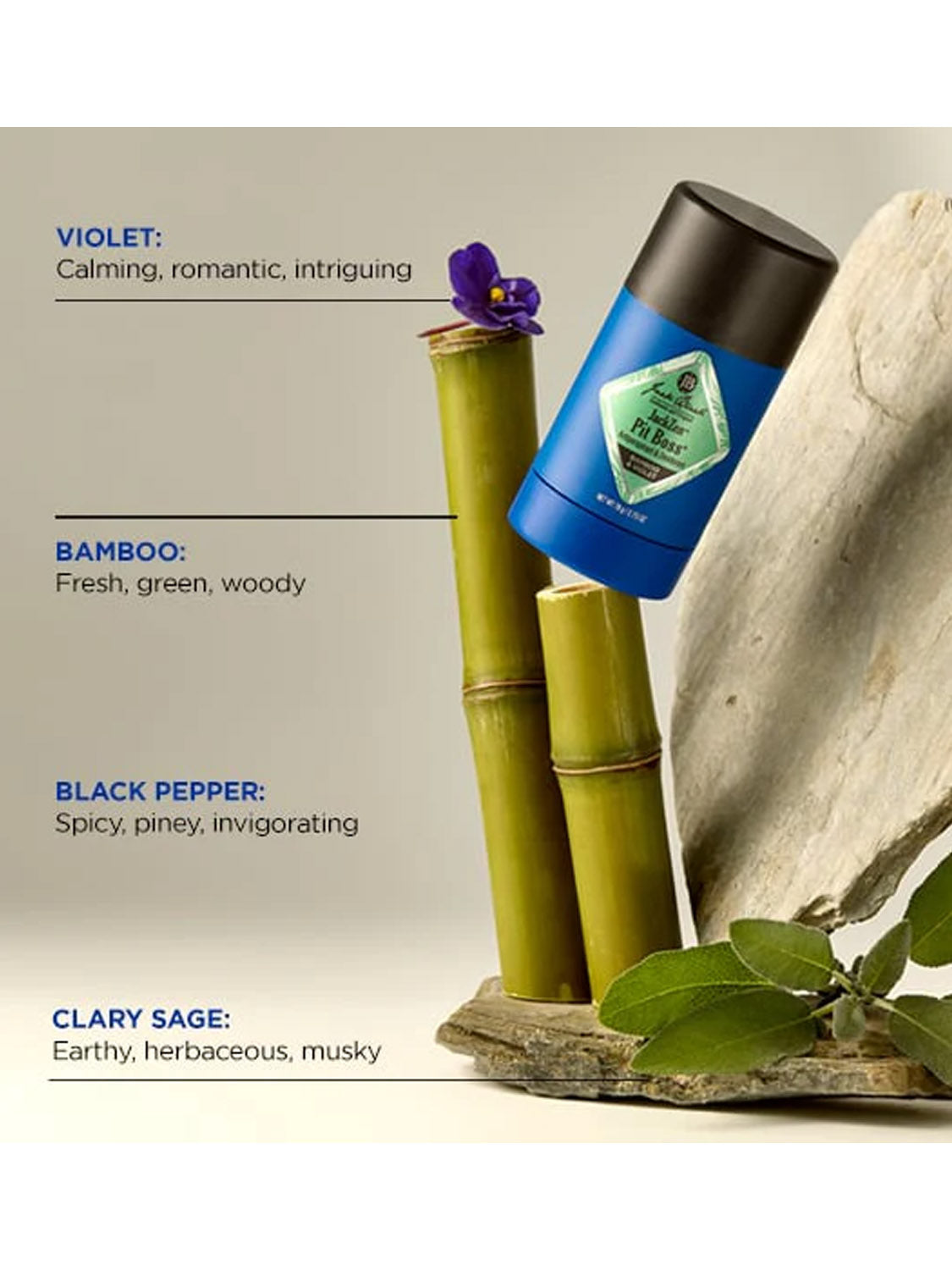 A blue Jack Black JackZen™ Pit Boss® Antiperspirant & Deodorant stick stands on upright bamboo and smooth stone, surrounded by violet flowers and green leaves. Labels highlight its soothing scent: violet, bamboo, black pepper, clary sage.