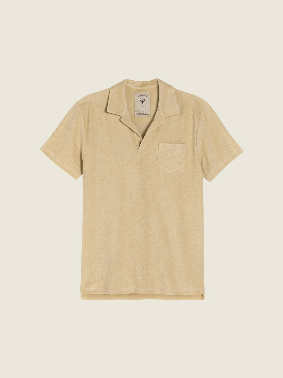 The OAS Polo Terry Shirt is a beige, short-sleeved shirt crafted from breathable cotton terrycloth, featuring an open collar and a small chest pocket, displayed flat on a light background.