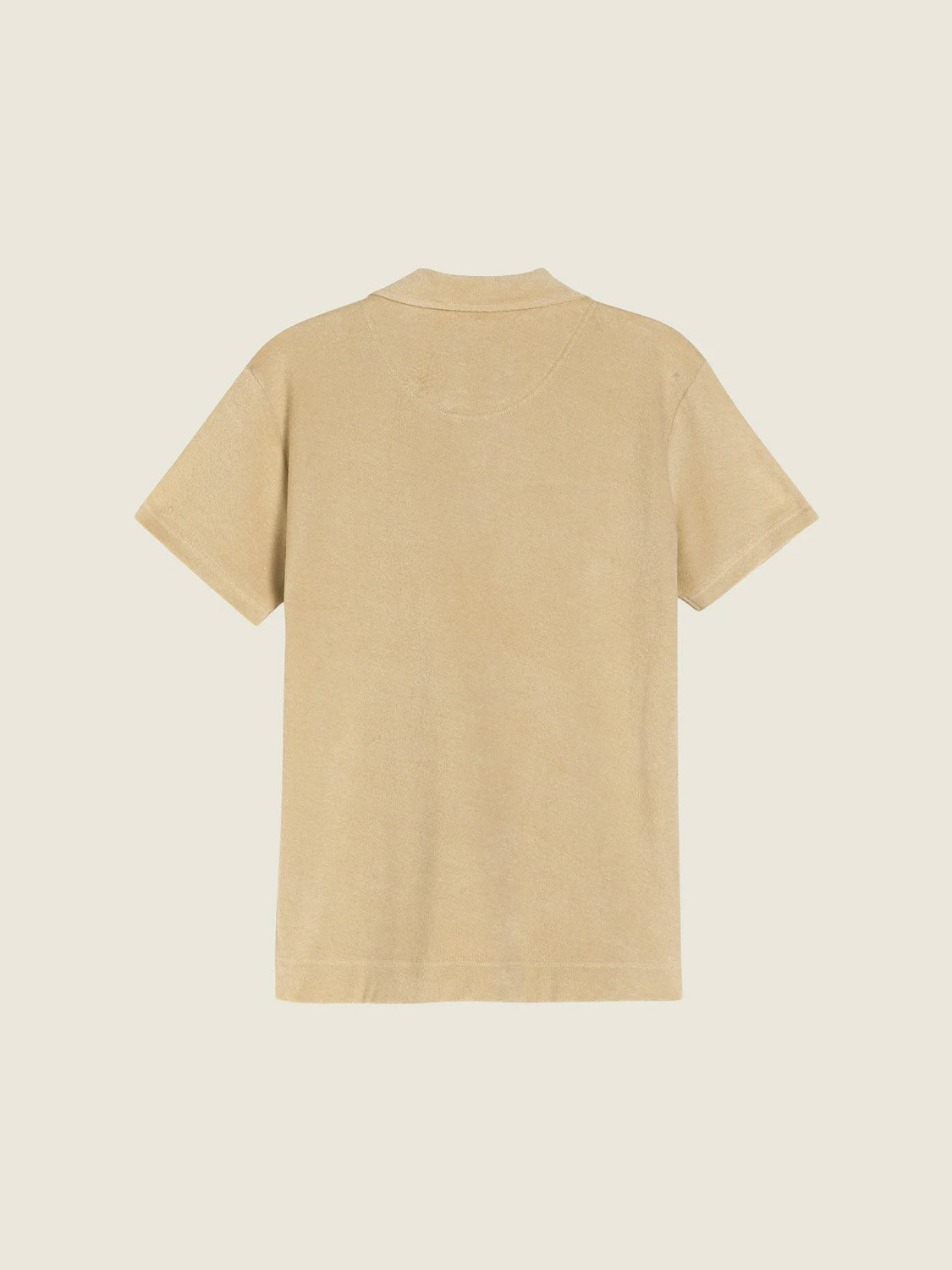 The OAS Polo Terry Shirt, a plain beige short-sleeve shirt made from breathable cotton terrycloth, is shown flat against a light background with the back view visible.