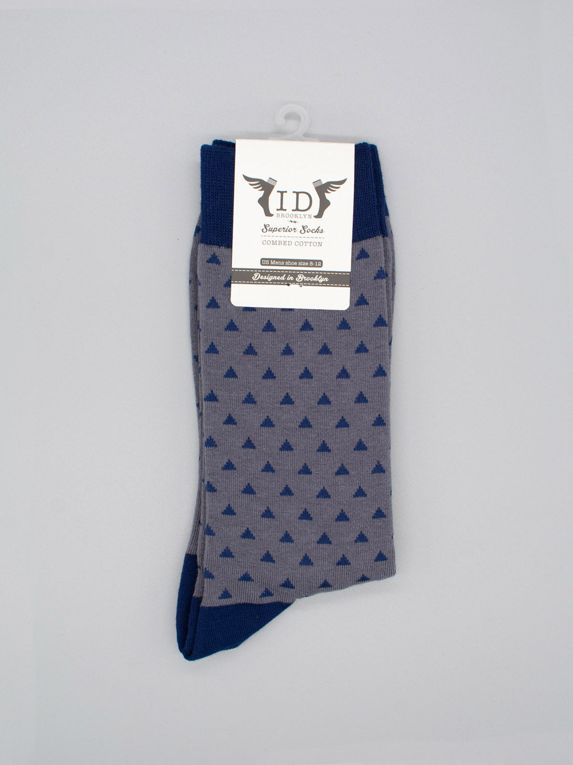 The Polygon Graphic Socks by ID Menswear are gray combed cotton socks with dark blue triangles and solid cuffs, toes, and heels. They come with a white label and fit men’s shoe sizes 8-12.