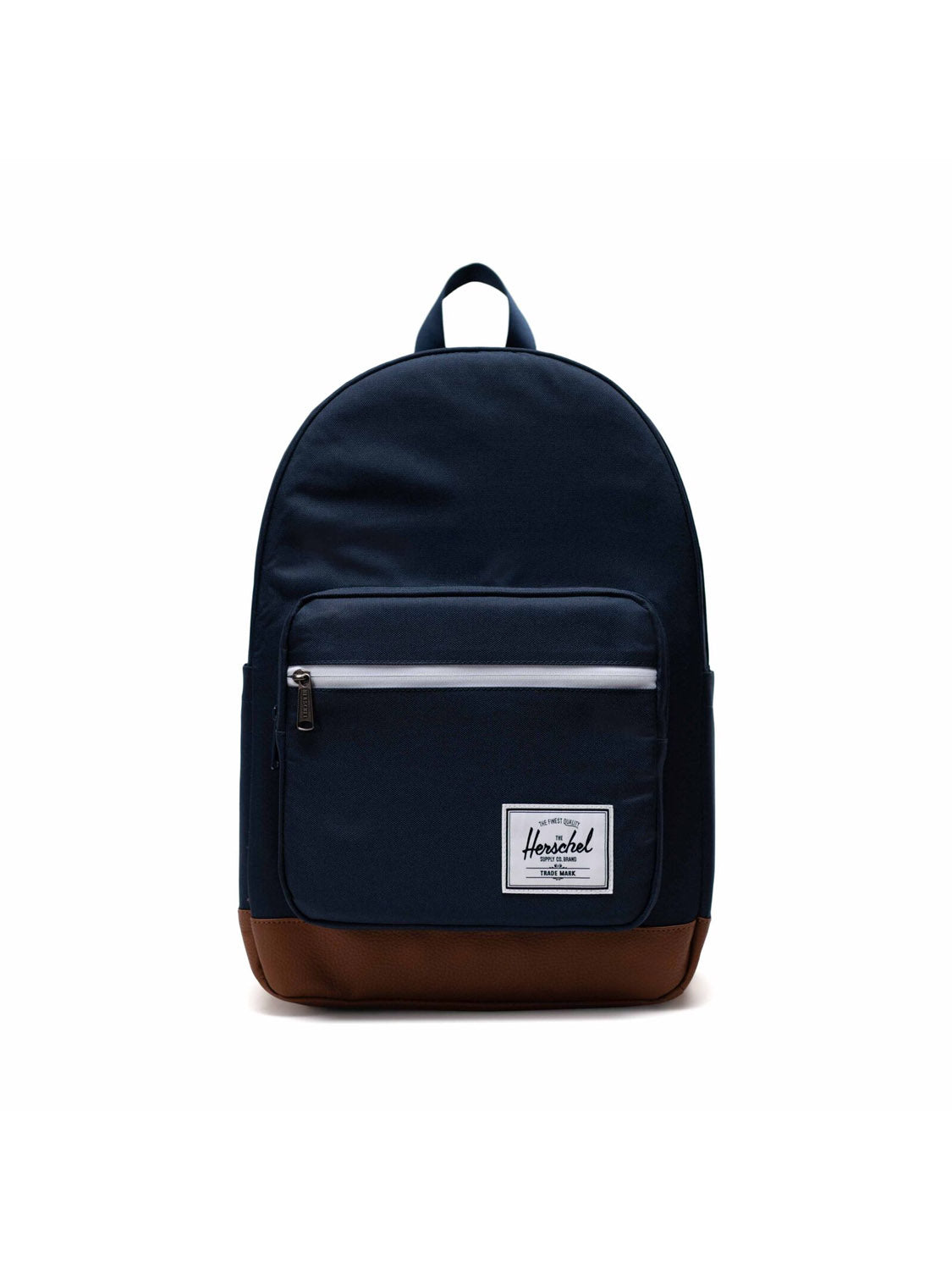The Herschel Pop Quiz Backpack is navy blue with a brown leather bottom, front zip pocket, top handle, and a small white logo patch. Made from EcoSystem fabric, it features a secure zipper closure on the main compartment.