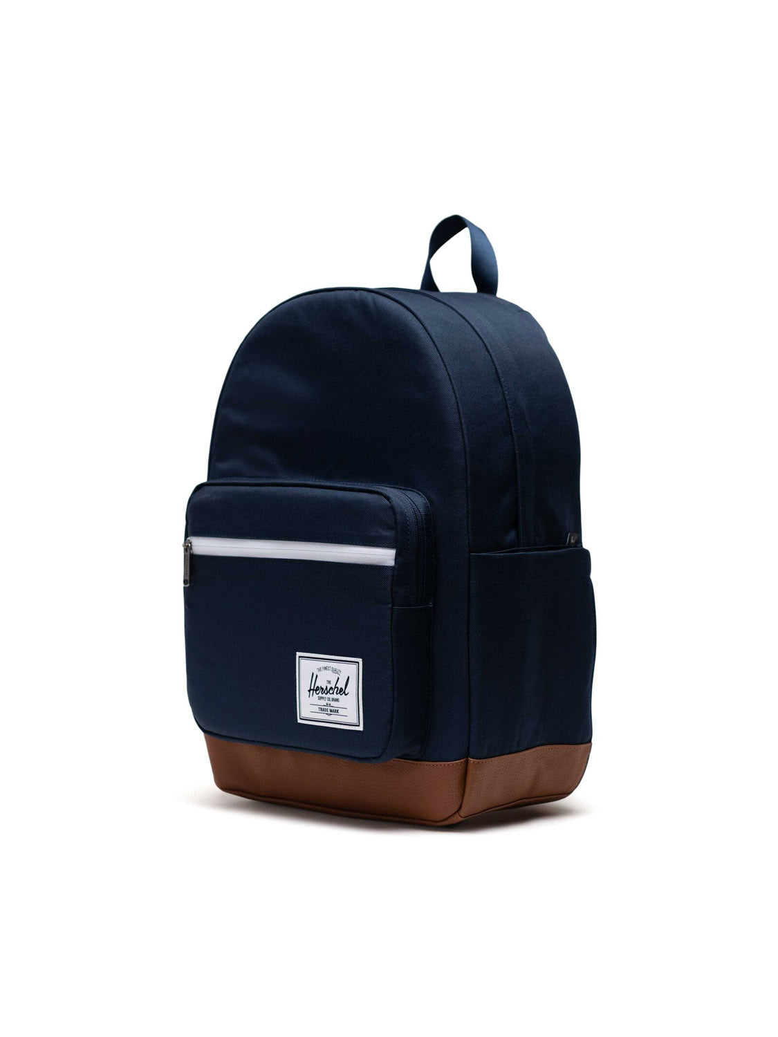 The Herschel Pop Quiz Backpack is navy blue with EcoSystem fabric, a brown leather-like bottom, a front zip pocket with a white zipper, top handle, and a white rectangular logo patch on the front.