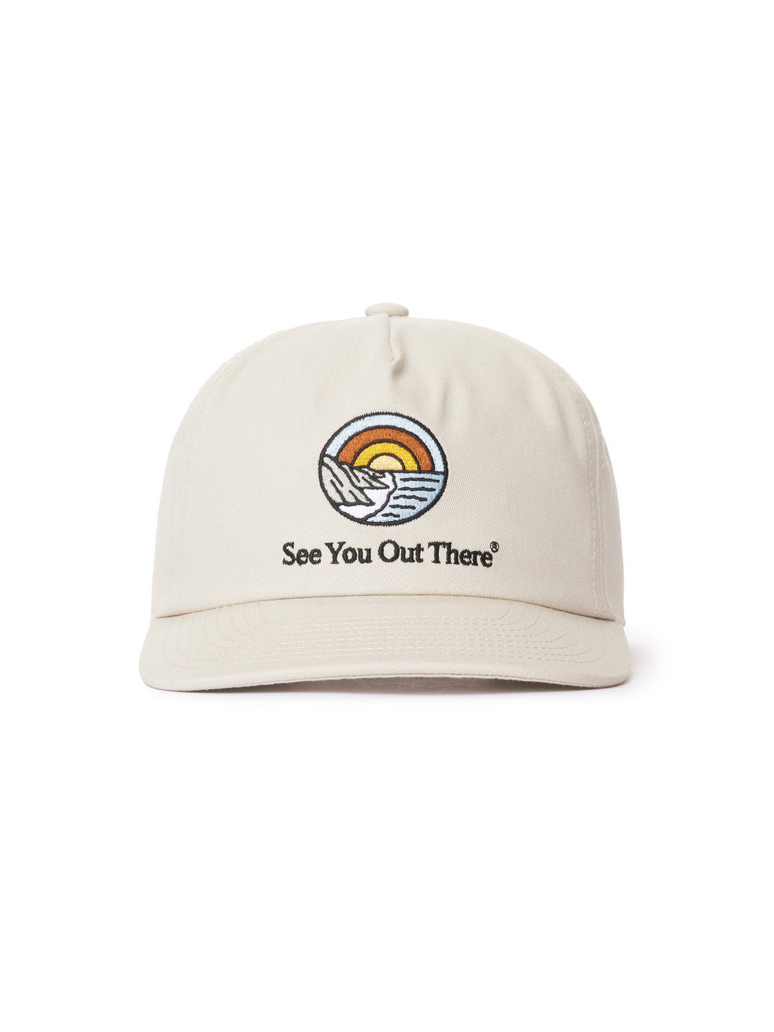 The Katin Reflection Twill Hat is a beige cotton twill baseball cap with custom embroidery of a sunset over mountains and waves, accompanied by the text See You Out There. It features an adjustable snapback closure.
