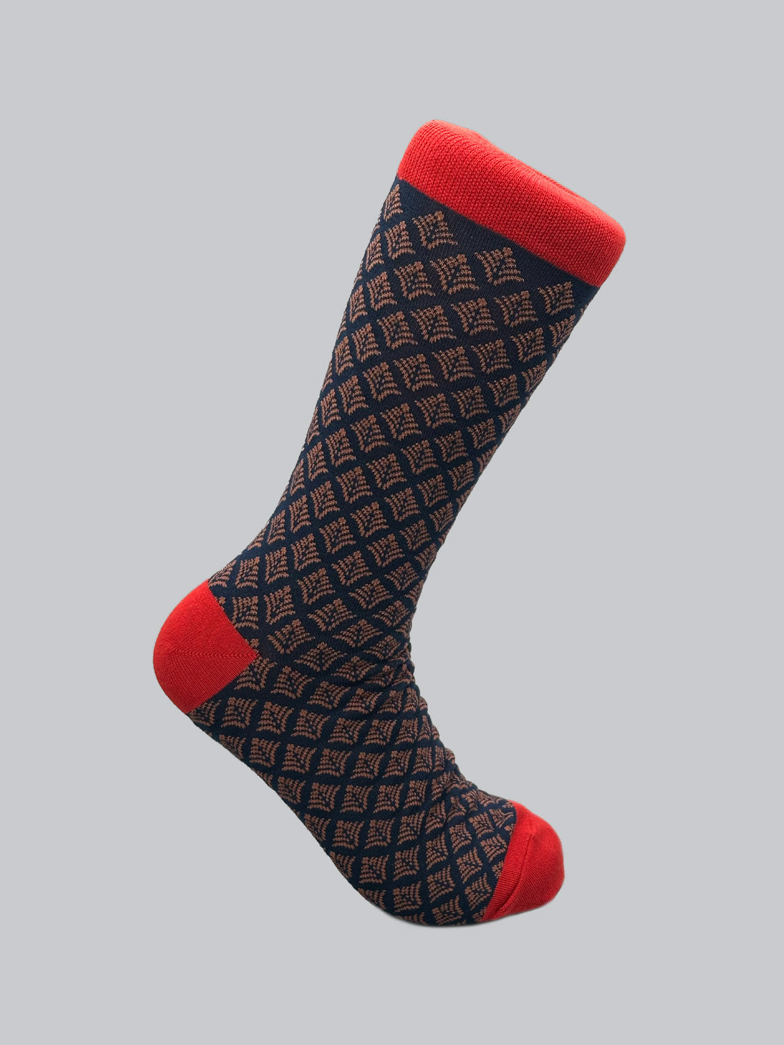 A single knee-high Retro Graphic Sock by ID Menswear features a vintage-inspired diamond pattern in dark blue and brown, with bright red toe, heel, and cuff for contrast. Crafted from premium combed cotton, this sock showcases an intricate geometric design.