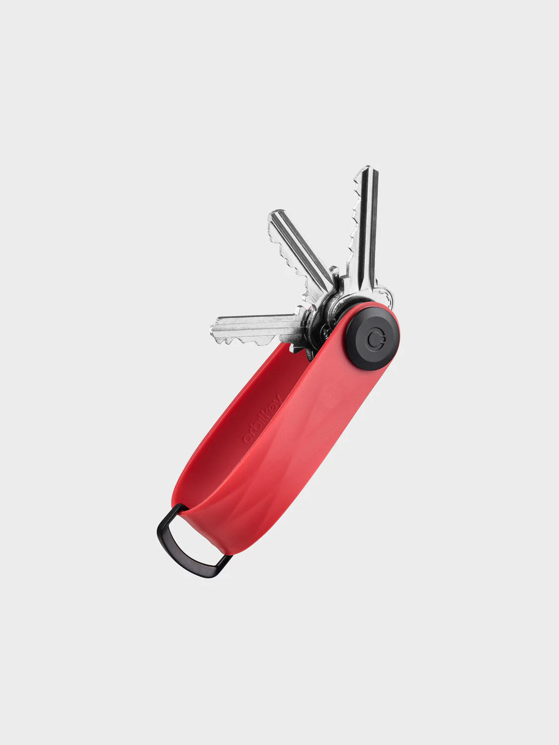 The Orbitkeys Key Organizer Rubber Active in red holds multiple silver keys, fanned out like a pocketknife, and features a black metal loop on one end. This durable key holder is shown against a plain light gray background.