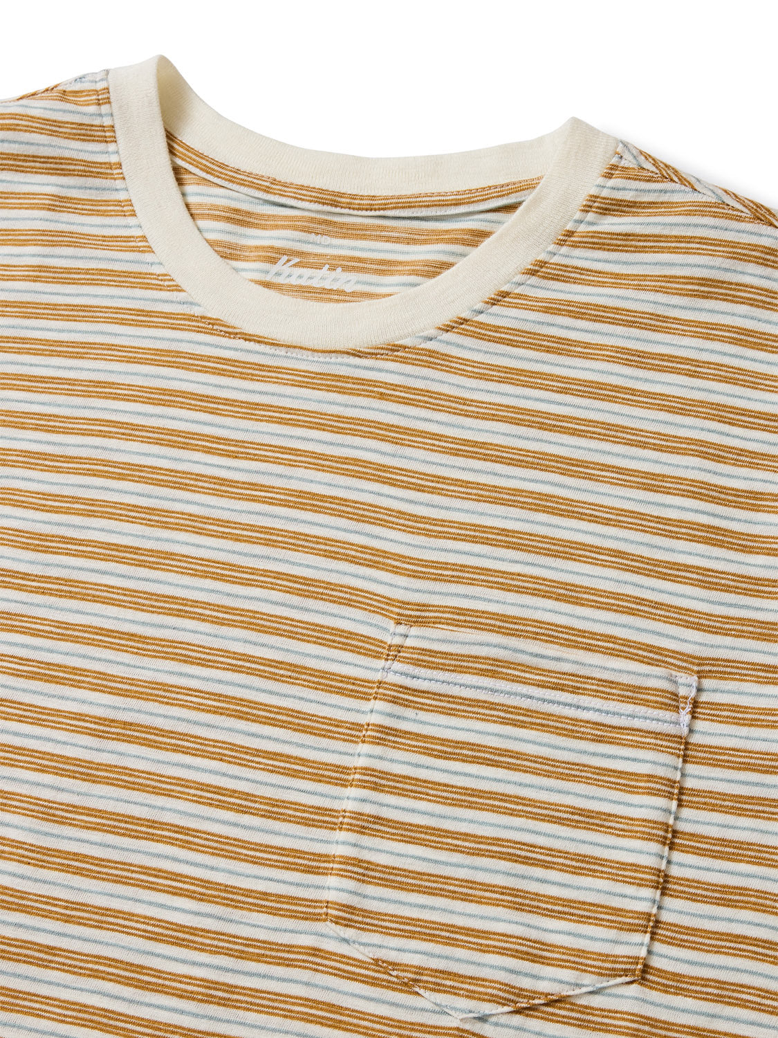 The Katin Rural Pocket Tee features horizontal tan and blue lines on a beige background, made from premium cotton. It includes a crew neckline and chest pocket, highlighting its unique stripe knit design.