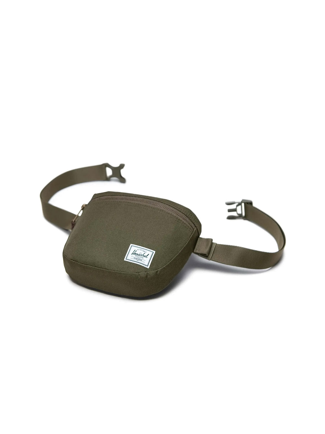 The Herschel Settlement Hip Pack in olive green is made from recycled fabric and features a front zipper pocket plus an adjustable strap with a plastic buckle for hands-free use. Shown on a white background.