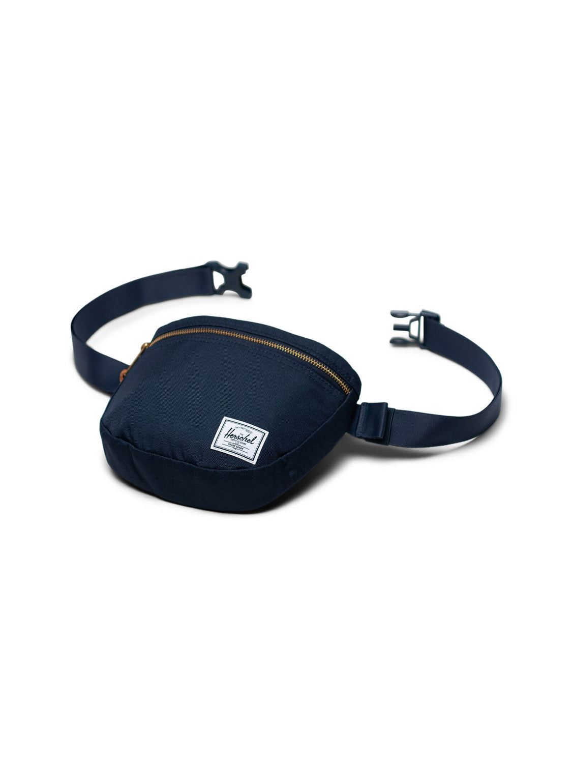 The Herschel Settlement Hip Pack in navy blue is crafted from recycled fabric, featuring a zippered main compartment, adjustable strap with plastic buckle, and a white front label. Ideal for hands-free journeys, it's shown against a white background.
