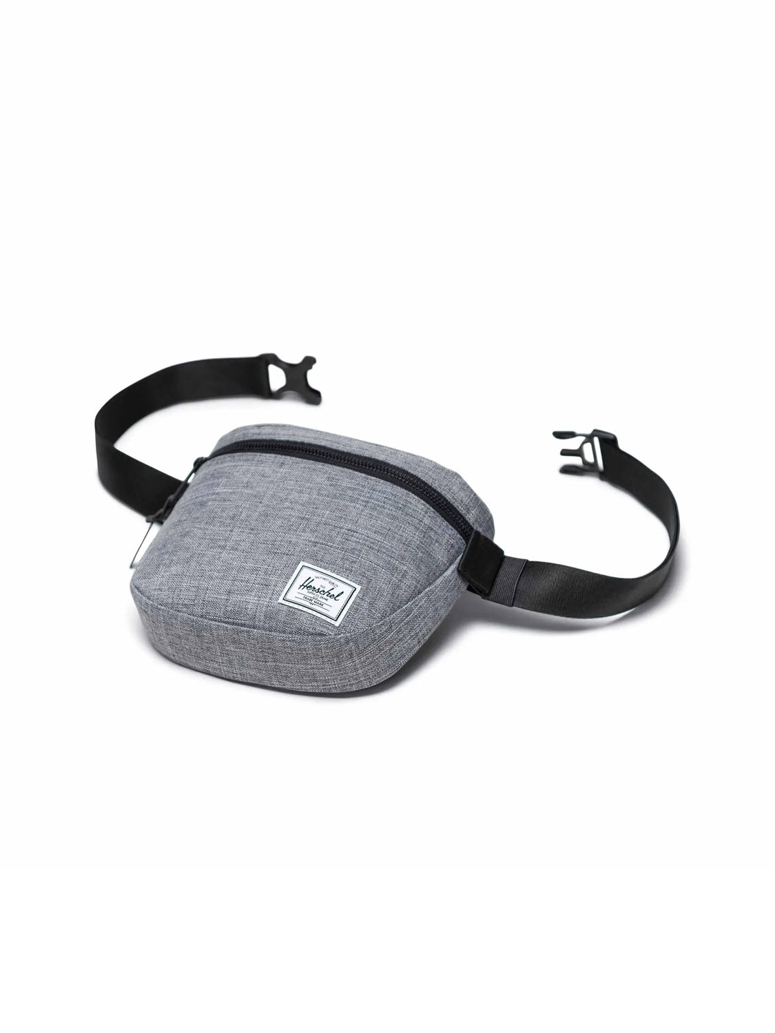 The Herschel Settlement Hip Pack is a gray, recycled-fabric hip pack with a black adjustable strap, plastic buckle, front zipper pocket, and white rectangular patch—ideal for hands-free journeys.