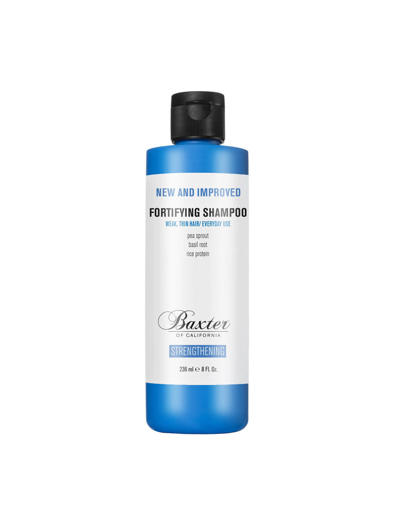 A blue and white bottle of Baxter Fortifying Shampoo labeled "New and Improved" for weak, thinning hair. This thickening formula with pea sprout, basil root, and rice protein strengthens hair for a fuller appearance.