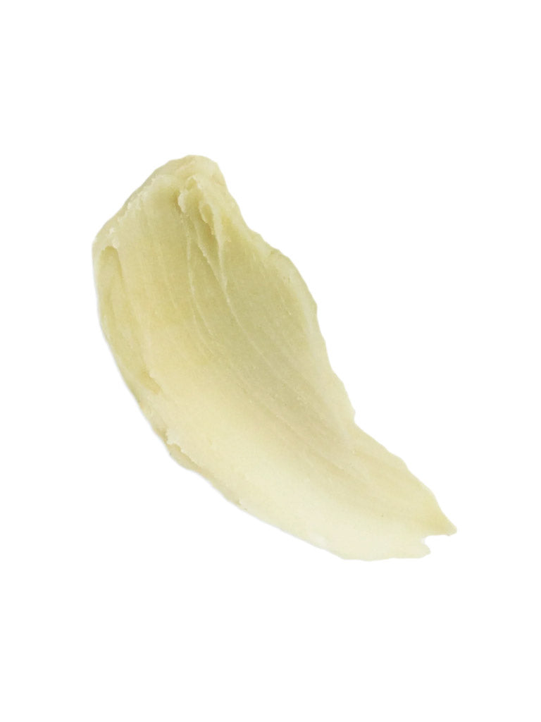 A smear of Baxter Shea Pomade Natural Finish and Shine, pale yellow and creamy with a smooth texture, is shown on a white background—ideal for moisturizing textured hair.