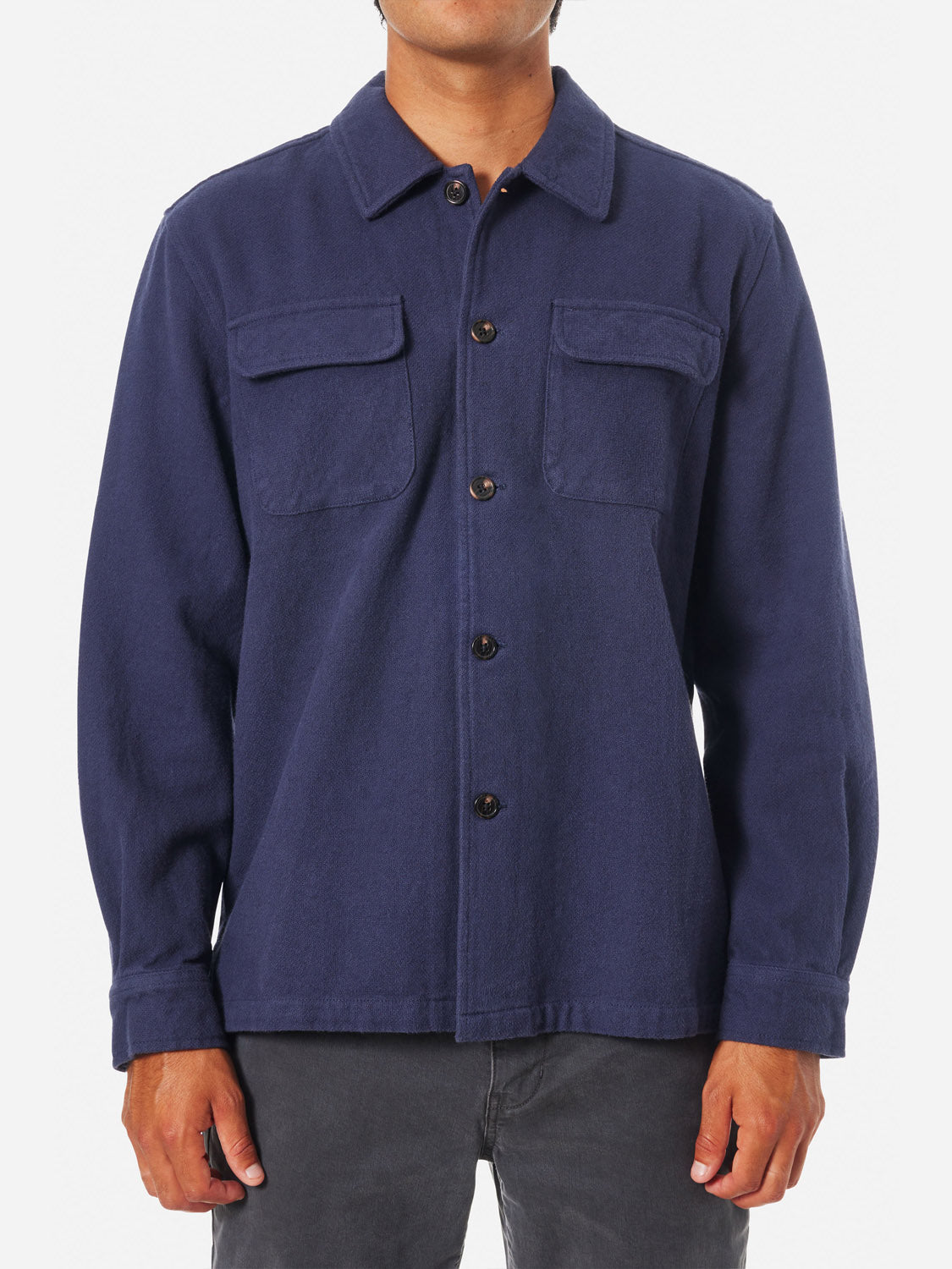 A person wearing the Katin Shiloh Solid Flannel Shirt in navy with two chest pockets, paired with black pants, stands against a plain white background.