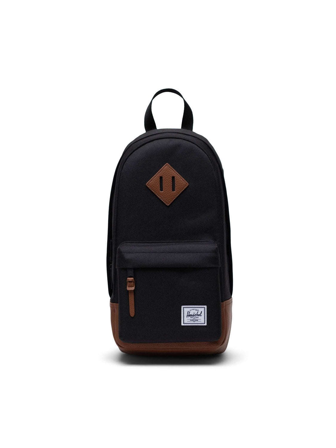 A black Herschel Heritage Shoulder Bag with brown accents, zippered front pocket, small white logo patch, and top handle is shown against a plain white background.